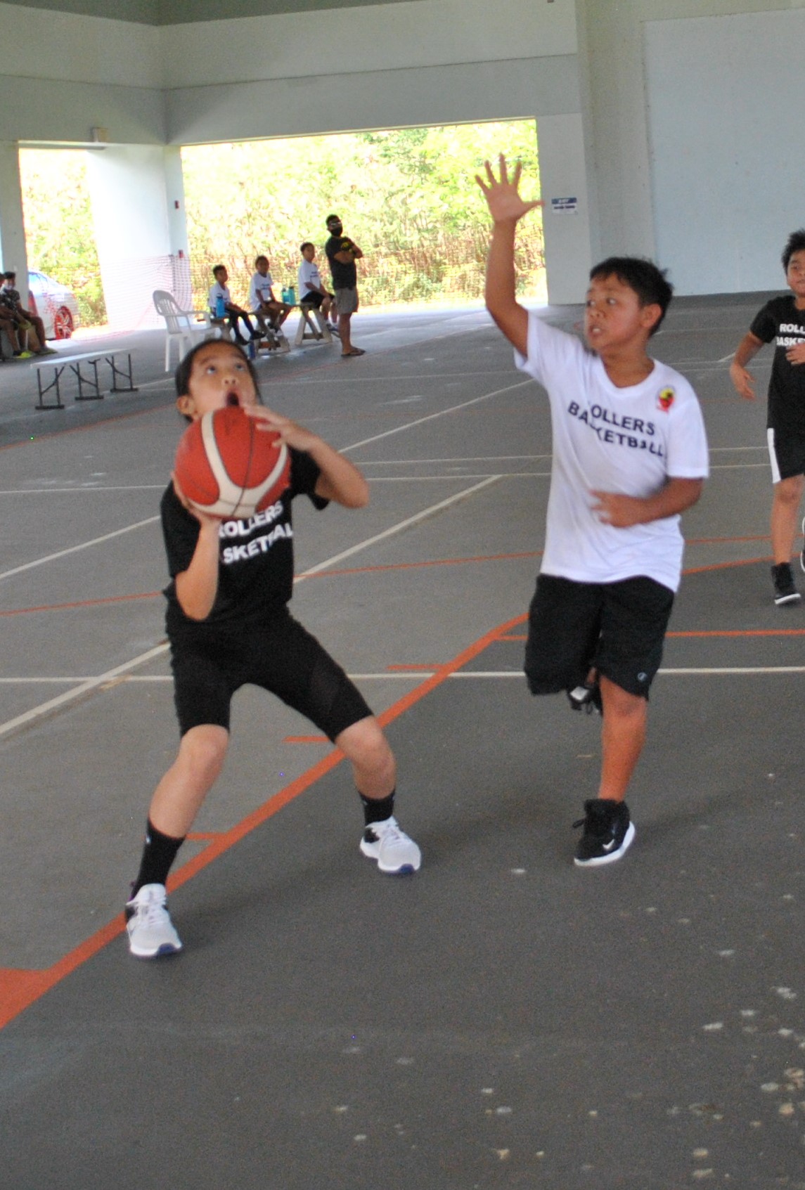 Team Black's Venice Enriquez goes for the shot during the U11 title game of the RBA Spring Madness on Saturday  at the Koblerville gym.Photo by James F. Sablan Jr.