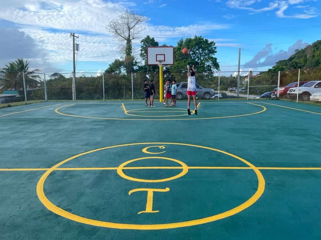Young community members enjoy the newly restored Chinatown basketball court on Monday.CNMI House Minority photo