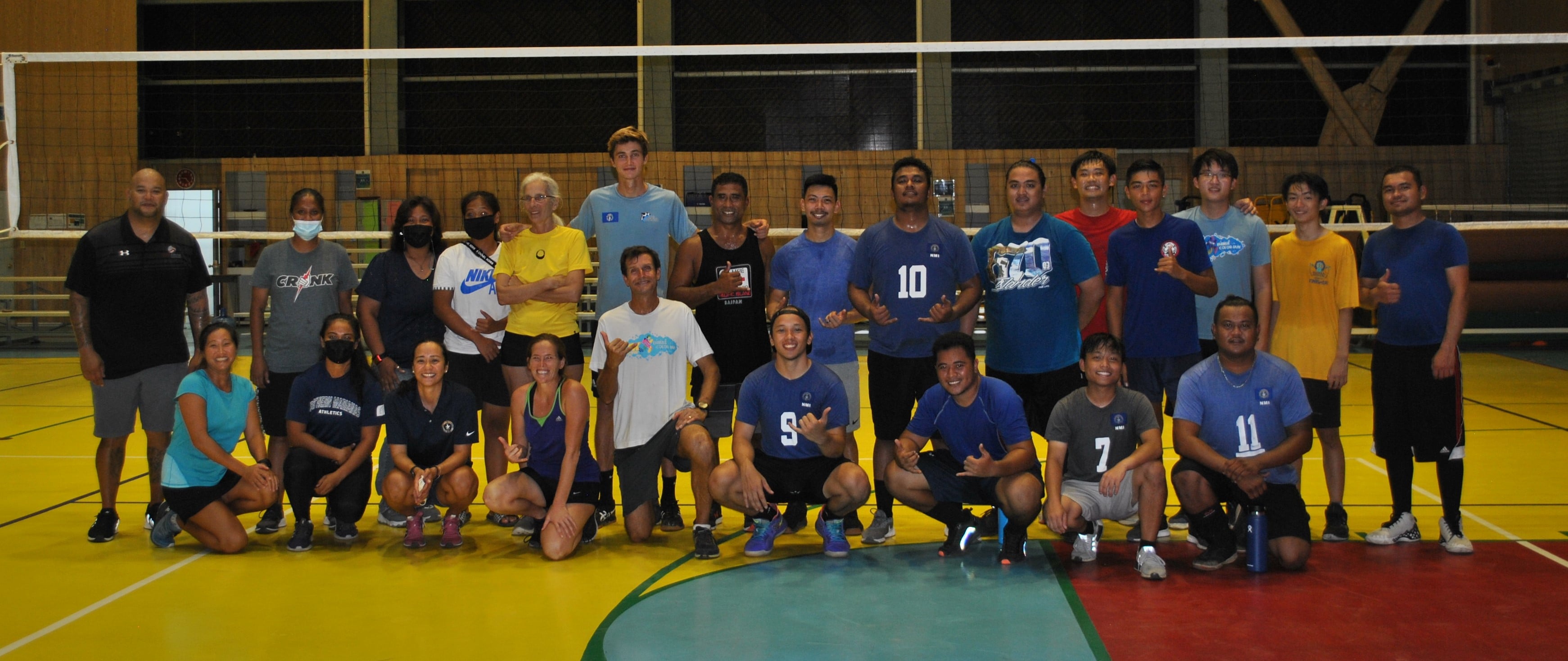 Coach Mike Rabago, left standing, poses with current and former CNMI men's national team players, coaches and other volleyball enthusiasts.Photo by James F. Sablan Jr.