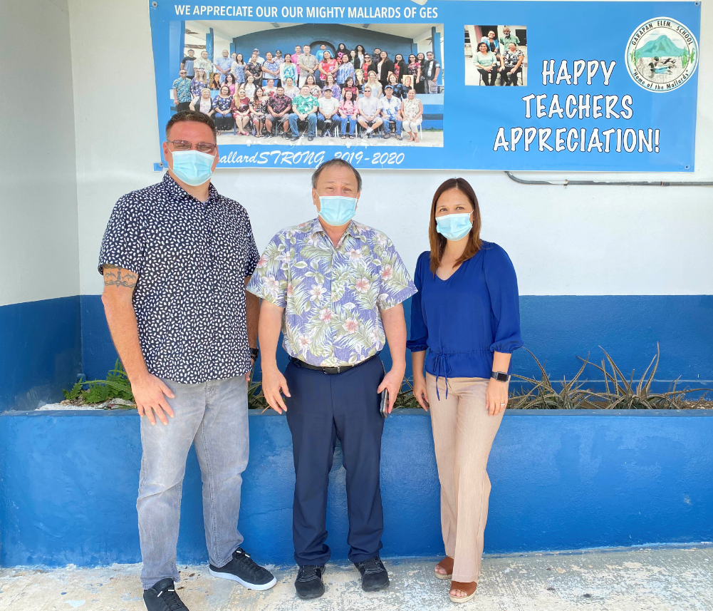 Board of Education Chairman Andrew L.  Orsini with Garapan Elementary School principal Liela Yumul and vice principal Derwin Johnson