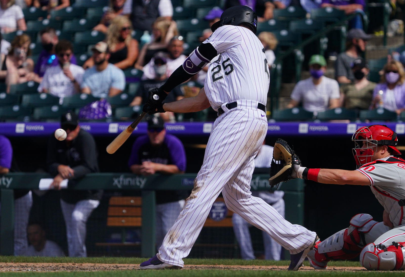 Colorado Rockies first baseman C.J. Cron (25) singles in the sixth inning against the Philadelphia Phillies at Coors Field in Denver, Colorado on April 25, 2021.Photo by Ron Chenoy-USA TODAY Sport