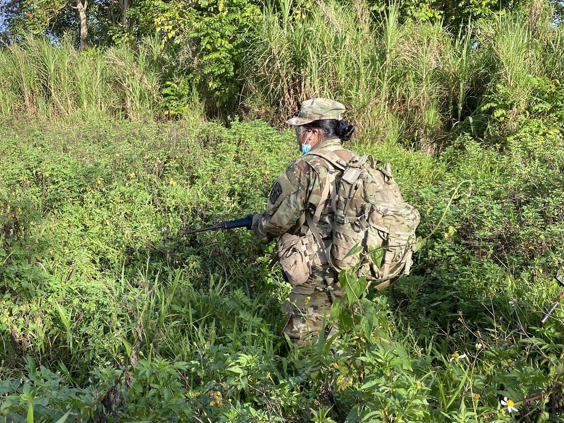 NMC ROTC Cadet Mariah Katelyn Gapasin stays motivated while carrying a ruck sack amid extreme heat on Guam during the ROTC Spring 2021 Field Training Exercise held on April 8-11, 2021.NMC photo