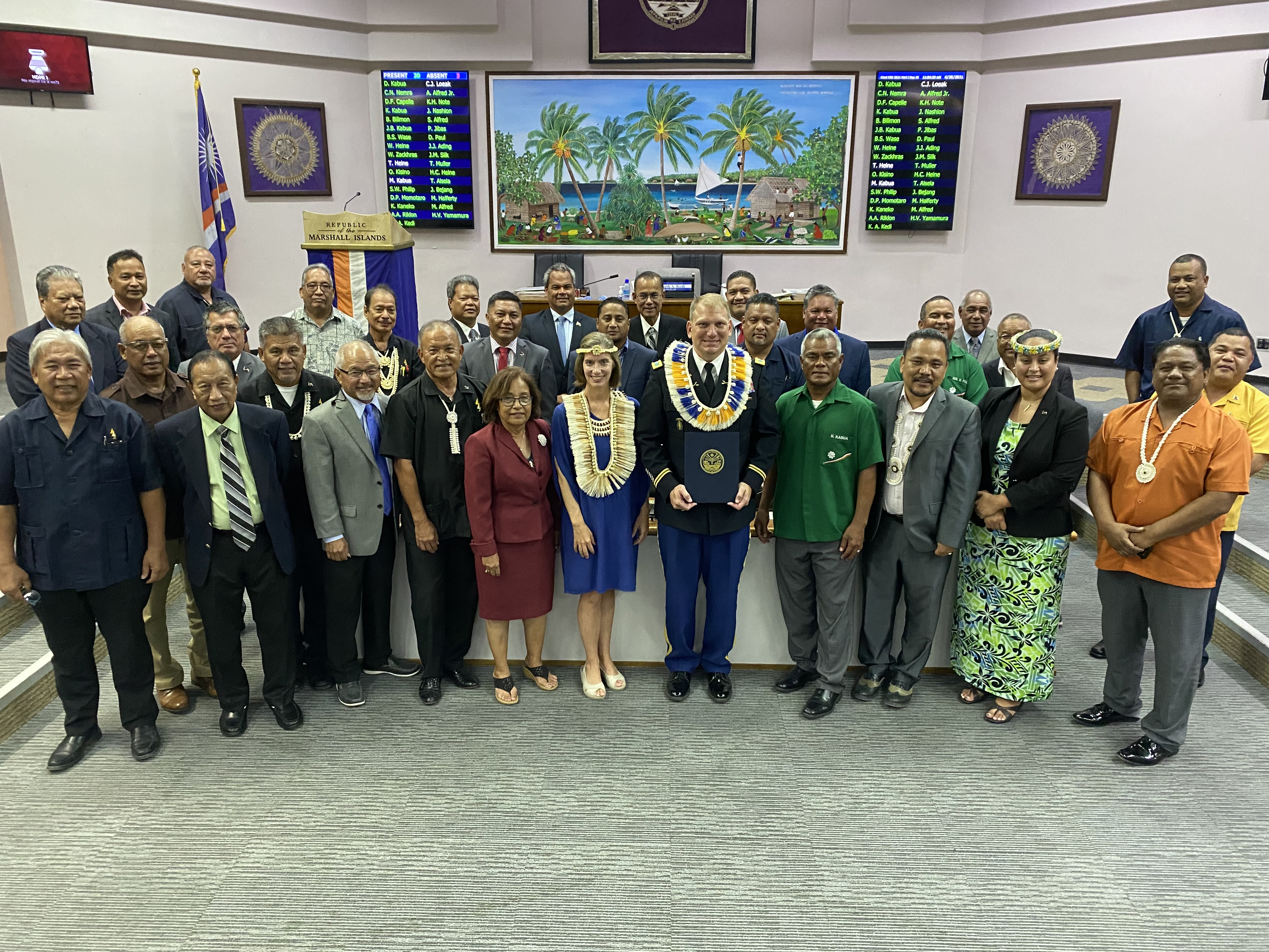 Following an extended and unprecedented ceremony to honor U.S. Army Col. Jeremy Bartel, center, with U.S. Ambassador Roxanne Cabral to his right, the entire membership of the Nitijela, Marshalls’ parliament,  joined them for a group photo.Photo by Giff Johnson