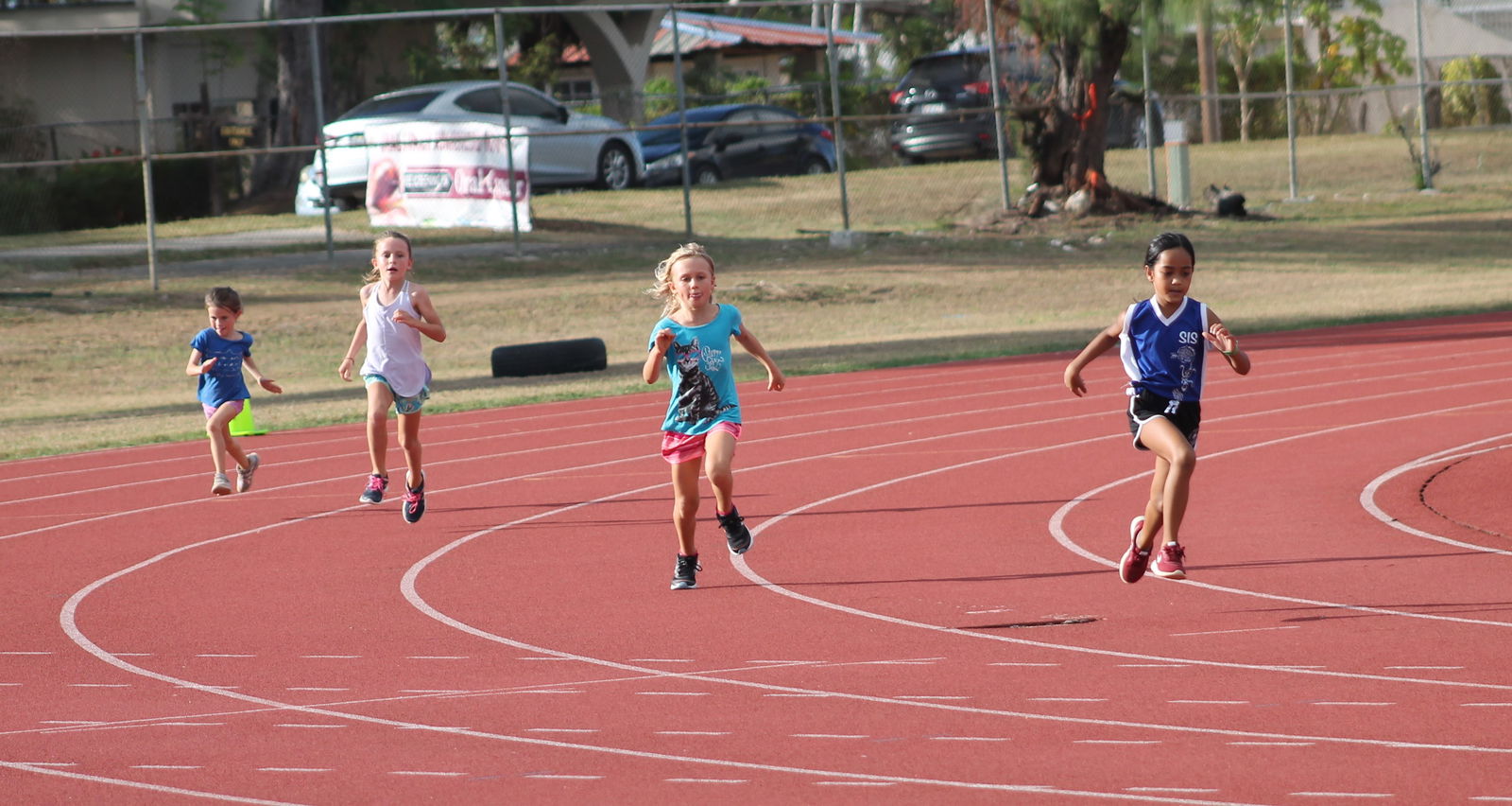 The girls in the U9 age group make a turn during the   PSS All School Track & Field qualifiers on Thursday at the Oleai Sports Complex.Photo by James F. Sablan Jr.