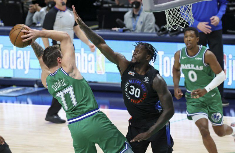 Dallas Mavericks guard Luka Doncic (77) passes the ball as New York Knicks forward Julius Randle (30) defends during the first quarter at American Airlines Center in Dallas, Texas, April 16, 2021.Photo by Kevin Jairaj-USA TODAY Sports