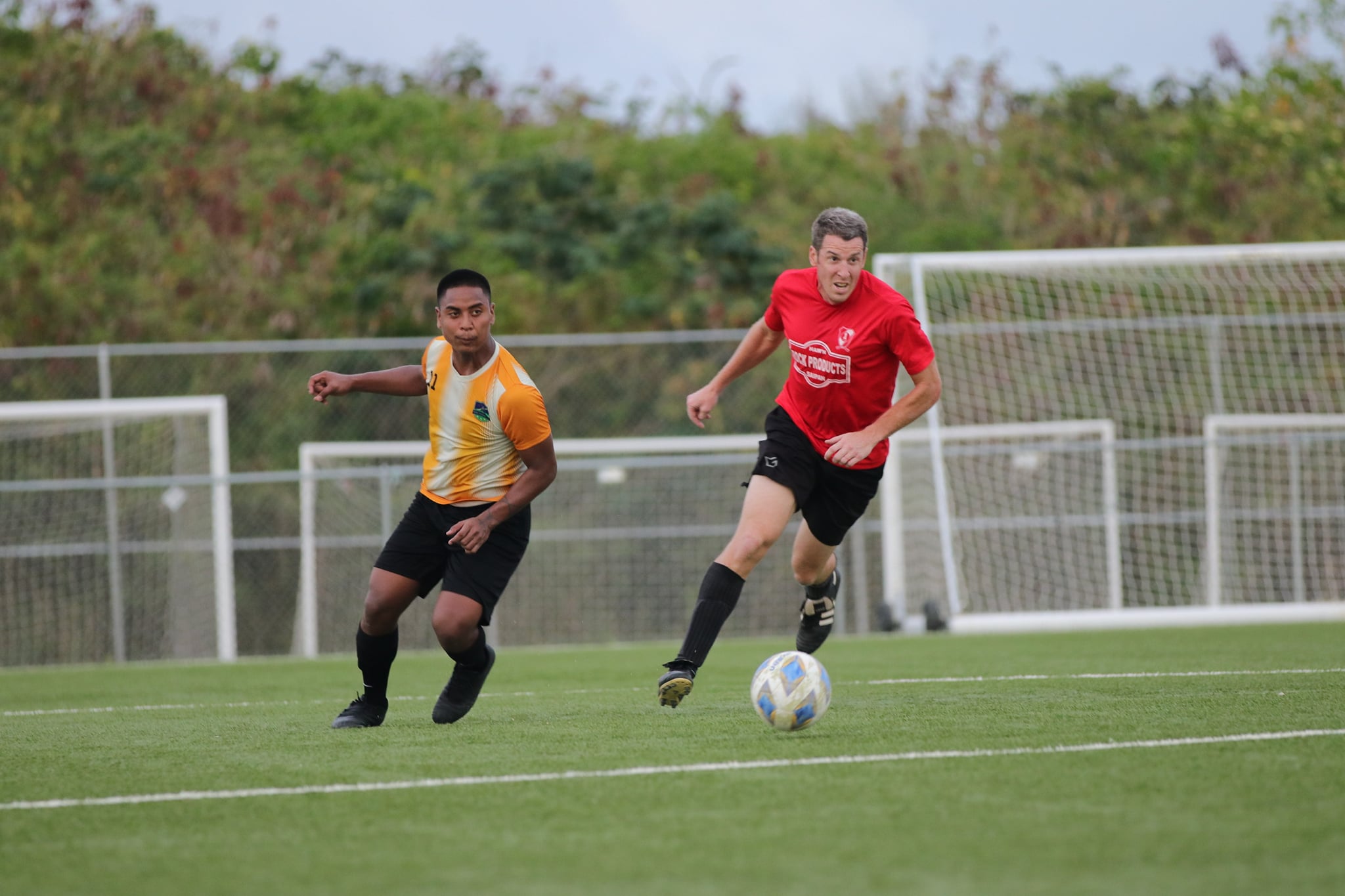 Paire Football Club’s Travis Spaeth is about to pass the ball as a defender closes in during a Division A game of the Men's M-League Spring 2021, Sunday, at the NMI Soccer Training Center.Contributed photo