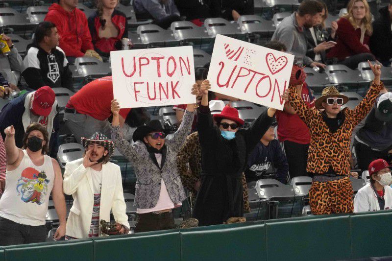Fans of Los Angeles Angels left fielder Justin Upton hold signs that read "Uptown Funk" in the fourth inning against the Minnesota Twins at Angel Stadium in Anaheim, California on April 16, 2021.Photo by Kirby Lee-USA TODAY Sports