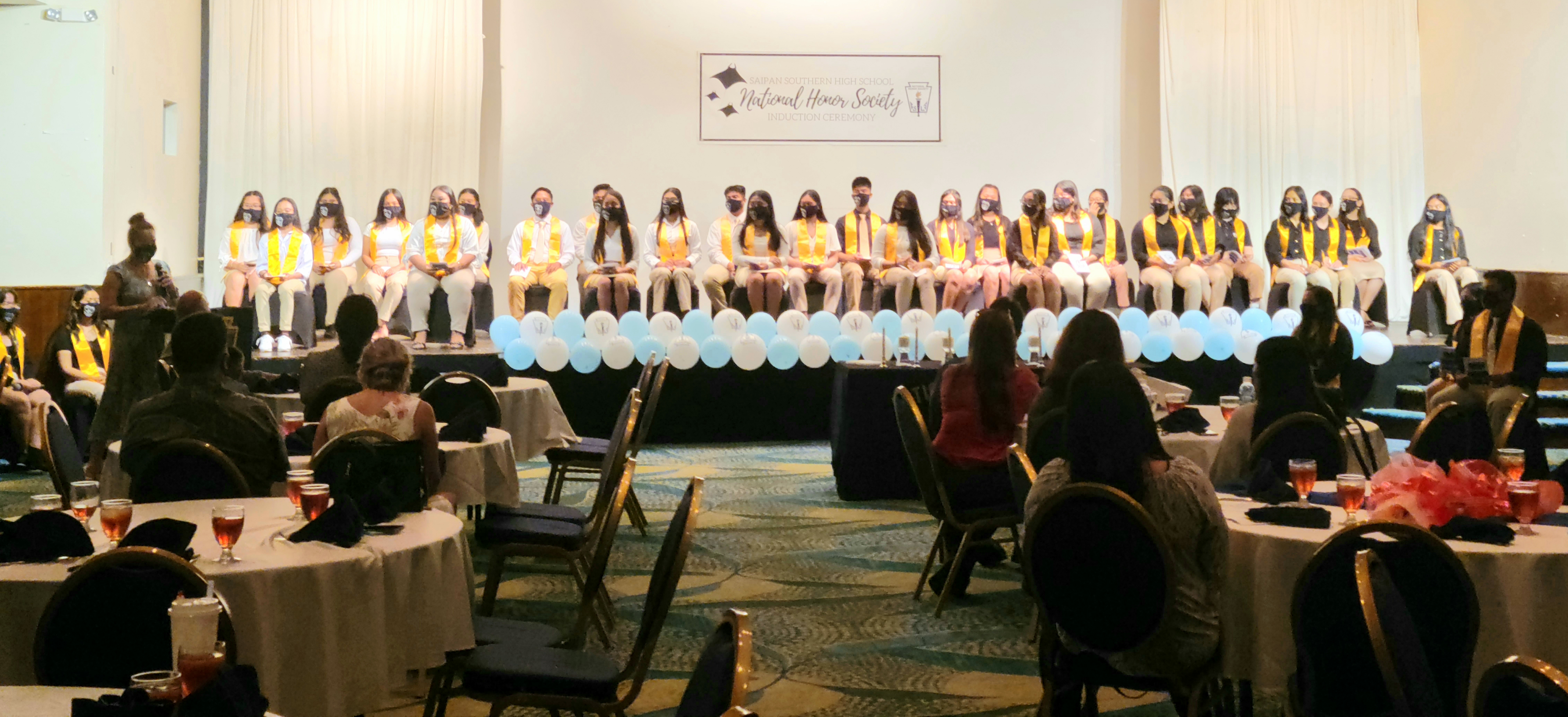 SSHS vice principal Arisa Sakai gives opening remarks as NHS-SSHS Chapter inductees look on.