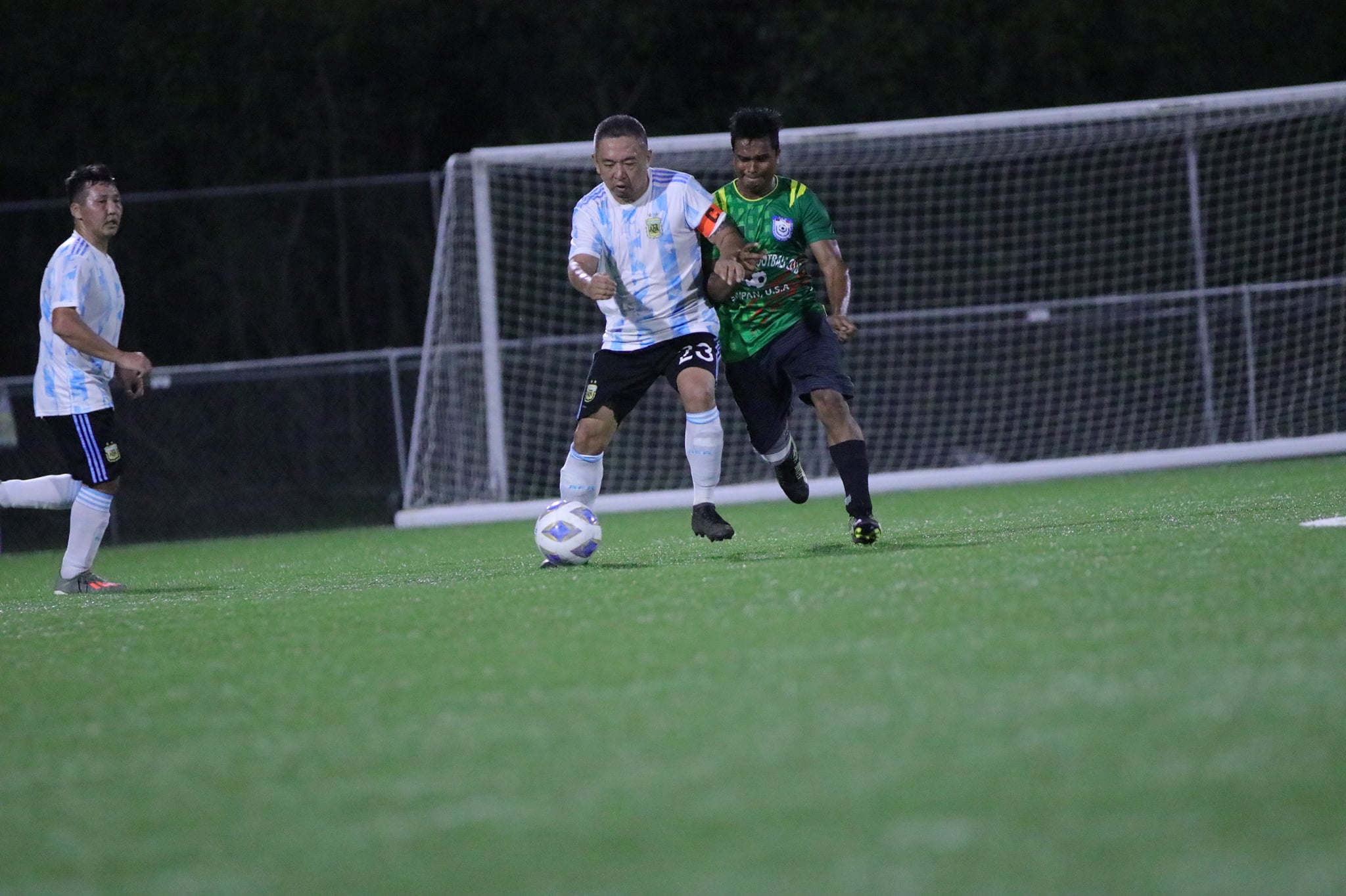 Saipan United's Kenneth Guo battles for possession against a Bangladesh Football Club player in a Division B game of the Men's M-League Spring 2021 at the NMI Soccer Training Center on Sunday.Contributed photo
