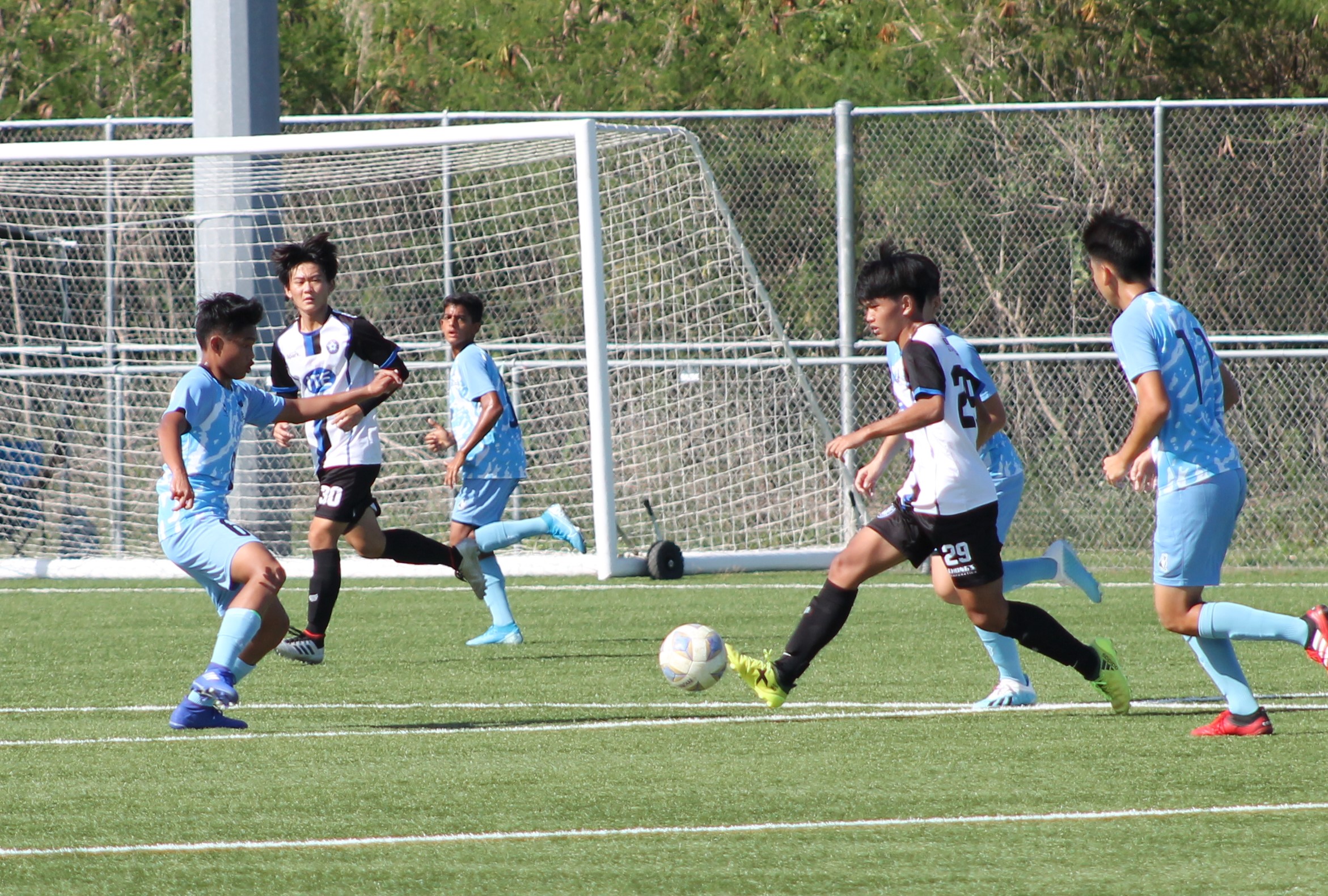 MP United's Razeff Altamirano dribbles against three defenders during a Men's M-League Spring 2021 game at the NMI Soccer Training Center.Photo by James F. Sablan Jr.