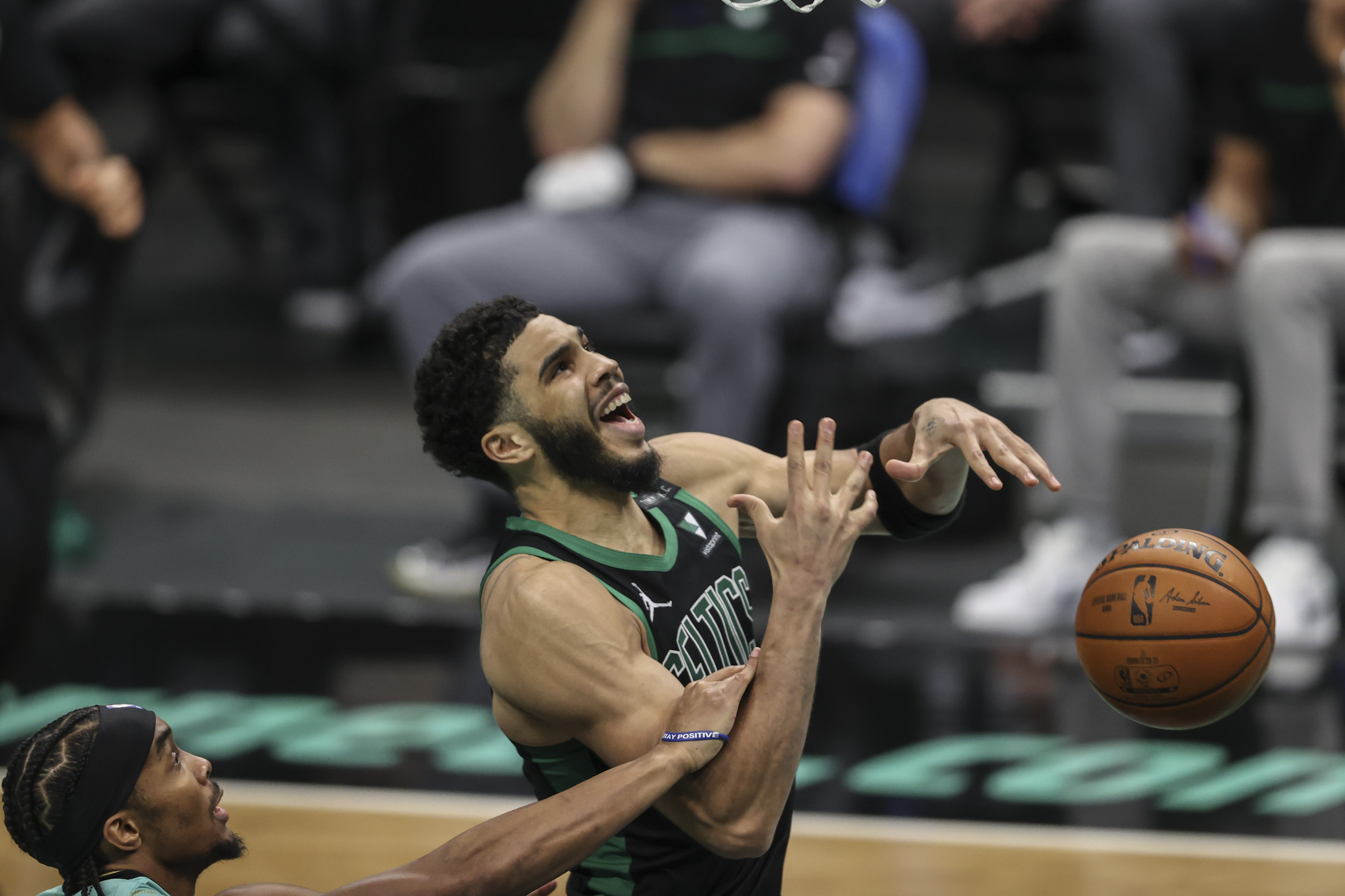 Boston Celtics forward Jayson Tatum (0) is fouled by Charlotte Hornets guard Devonte' Graham (4) in the second half at Spectrum Center in Charlotte, North Carolina on April 25, 2021. The Charlotte Hornets won 125-104.Photo by Nell Redmond-USA TODAY Sports