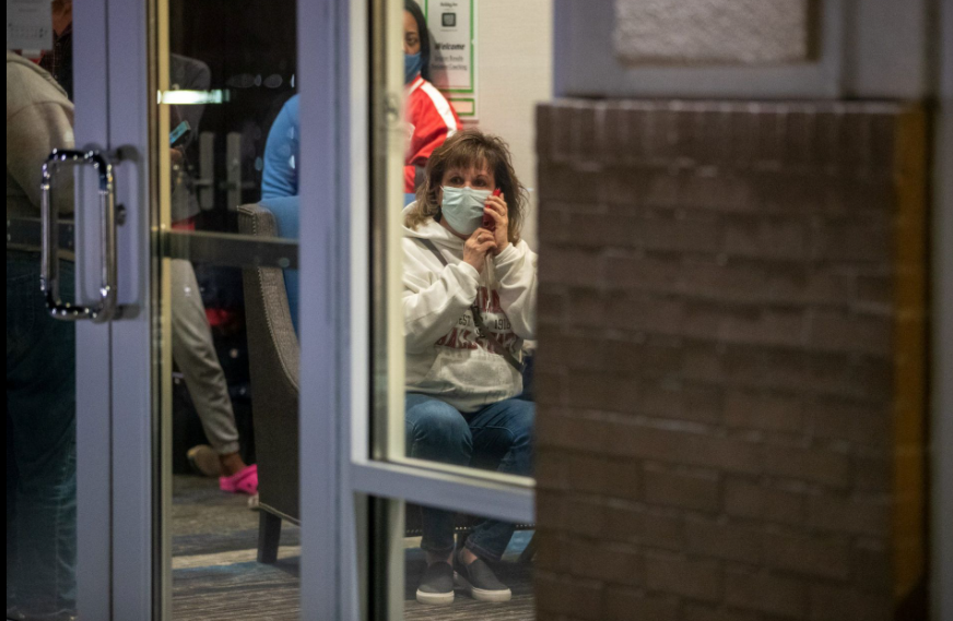 Family members await information about their loved ones who work at the FedEx facility after a mass casualty shooting in Indianapolis, Indiana, April 16, 2021.Photo by Mykal McEldowney/IndyStar/USA Today Network via REUTERS
