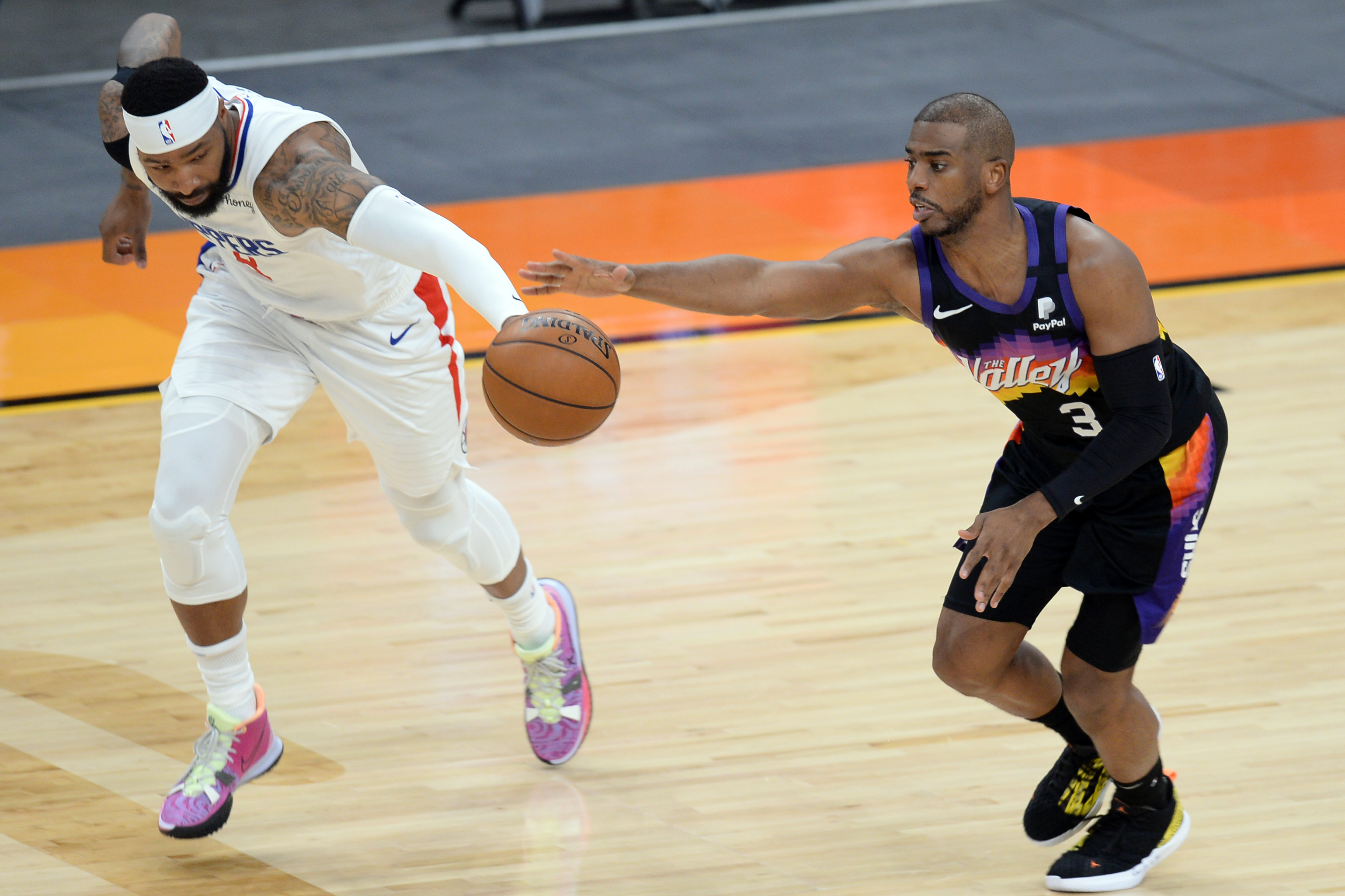 Phoenix Suns guard Chris Paul (3) outreaches LA Clippers forward Marcus Morris Sr. (8) for the ball during the second half at Phoenix Suns Arena in Phoenix, Arizona on April 28, 2021.Photo by Joe Camporeale-USA TODAY Sports