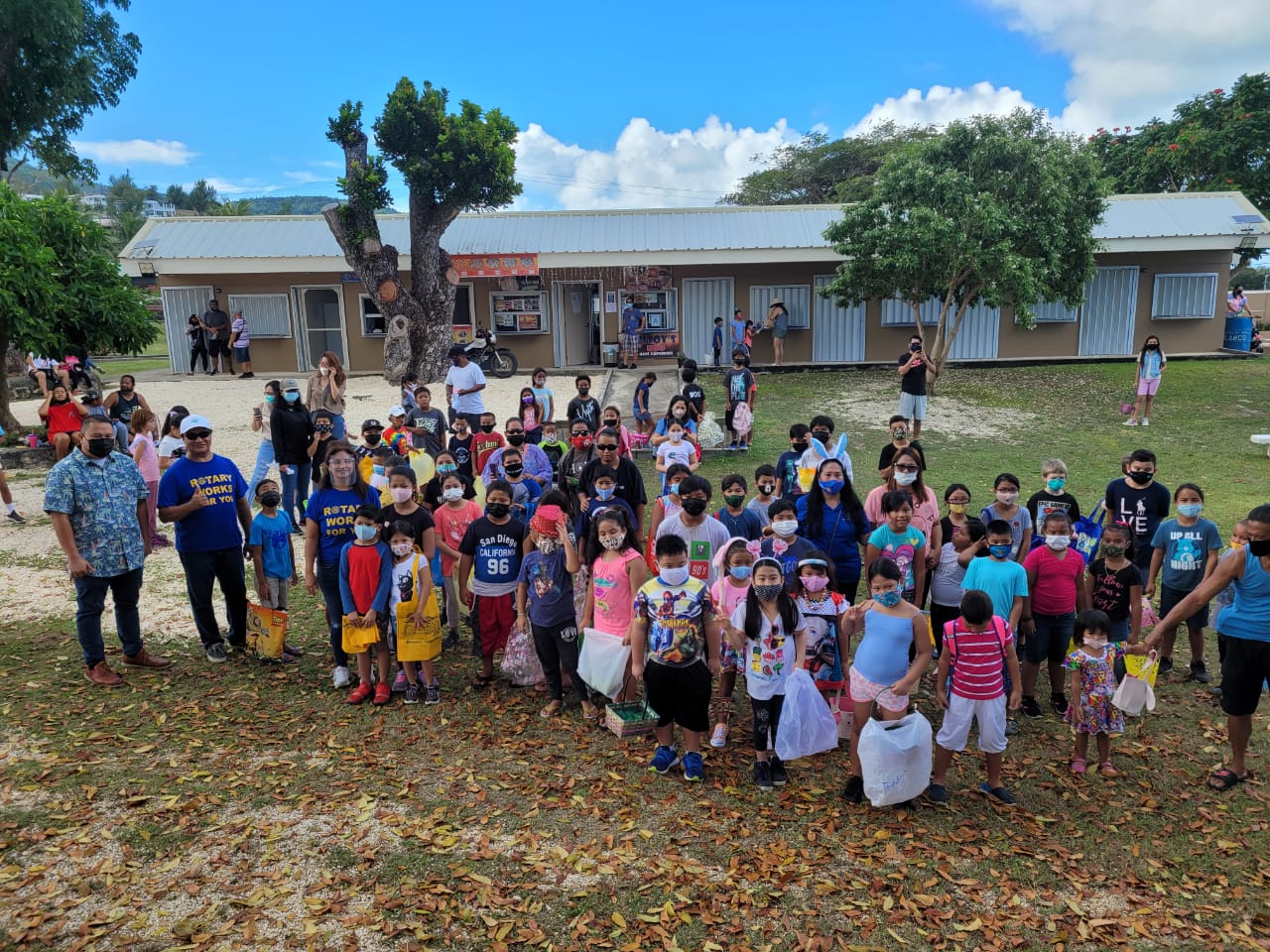 Middle school and elementary students pose for a group photo with Rotarians before the start of the Rotary Club’s Easter Egg Hunt at Sugar King Park in Garapan on Saturday.Photo by Emmanuel T. Erediano