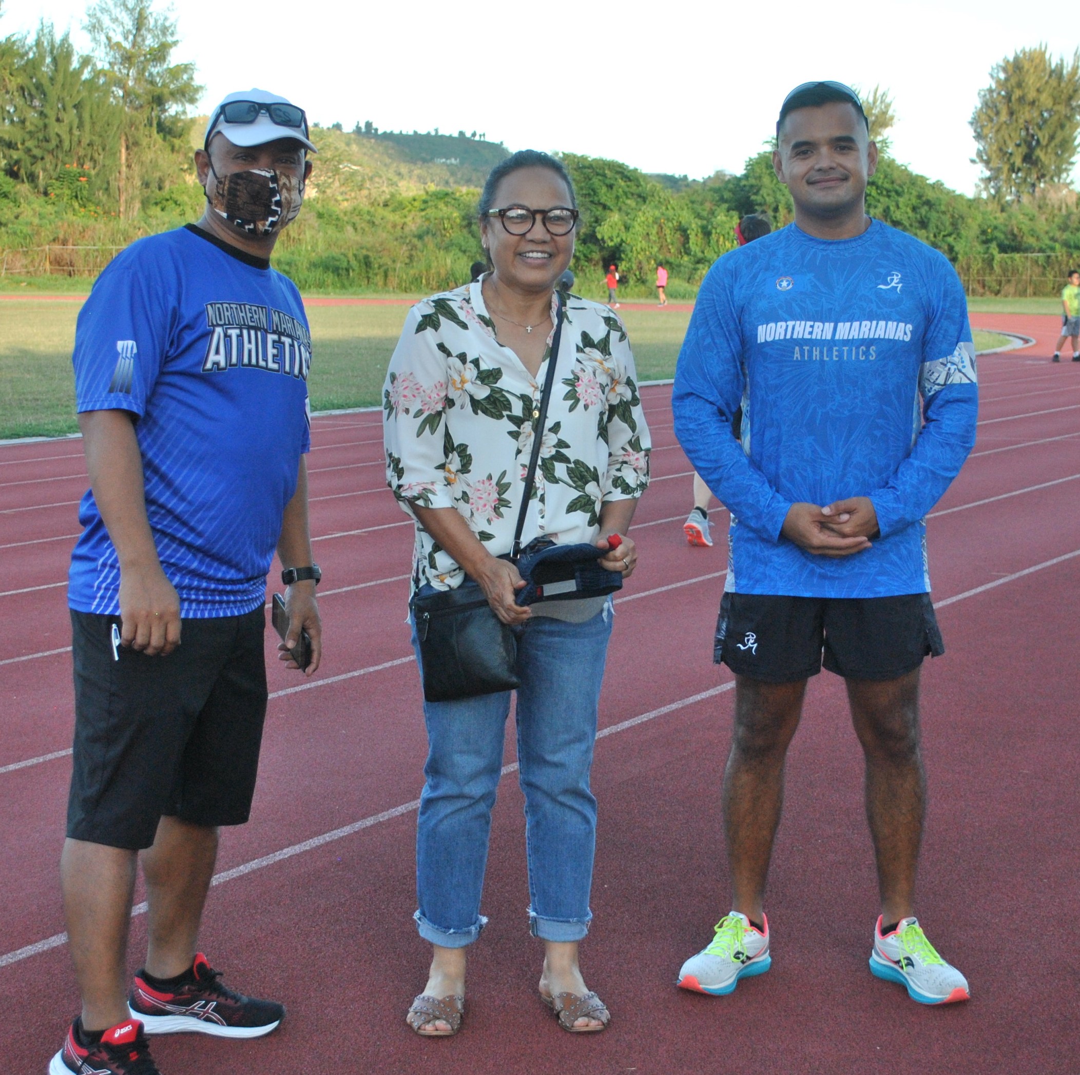 Juanita Fajardo of the 60-64 age group poses with Northern Marianas Athletics' Robin Sapong and Edward Dela Cruz Jr. during Thursday's awards ceremony at the Oleai Sports Complex.Photo James F. Sablan Jr.