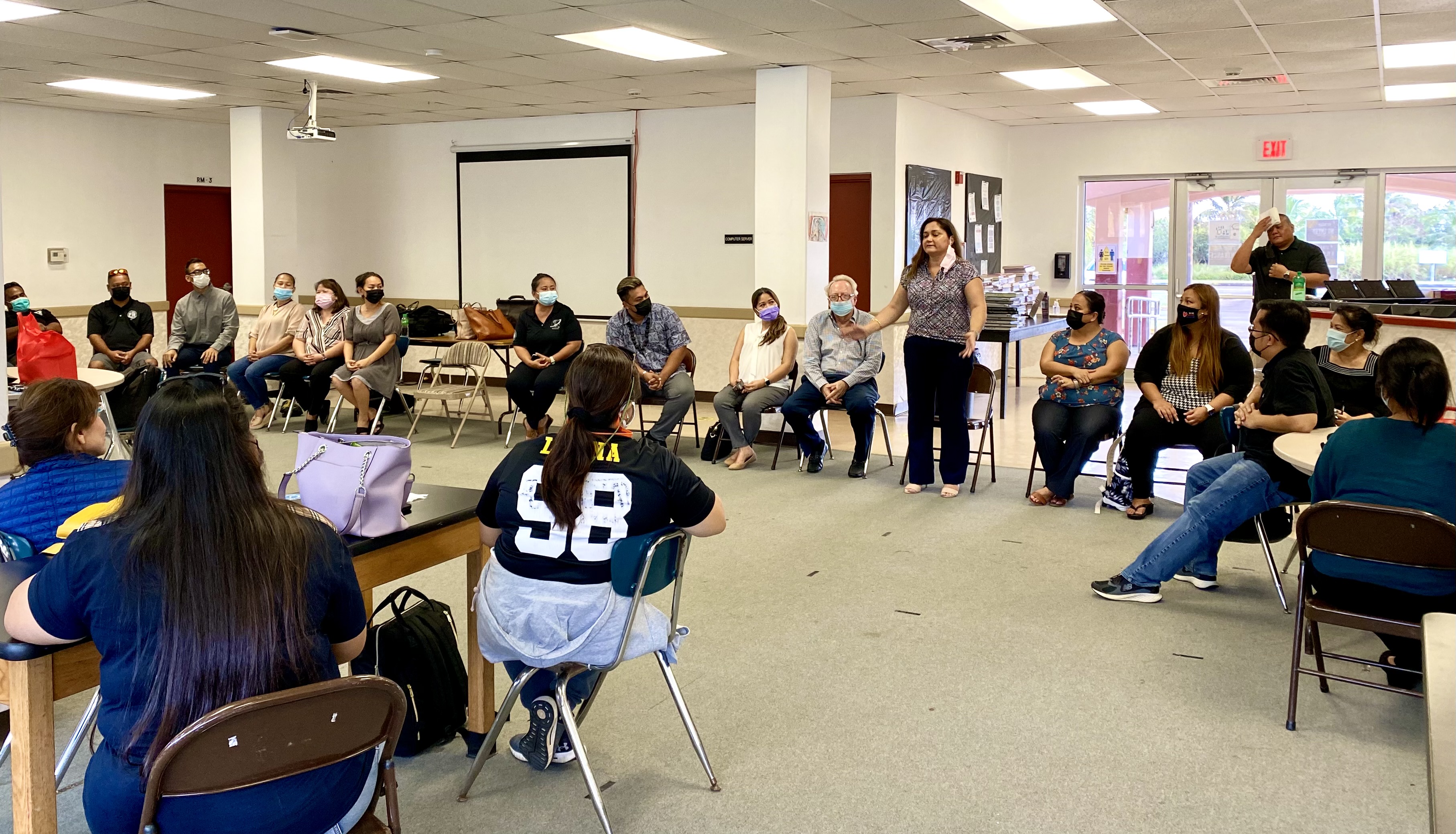 Public School System special education program director Donna Flores speaks with Tinian staff and personnel.