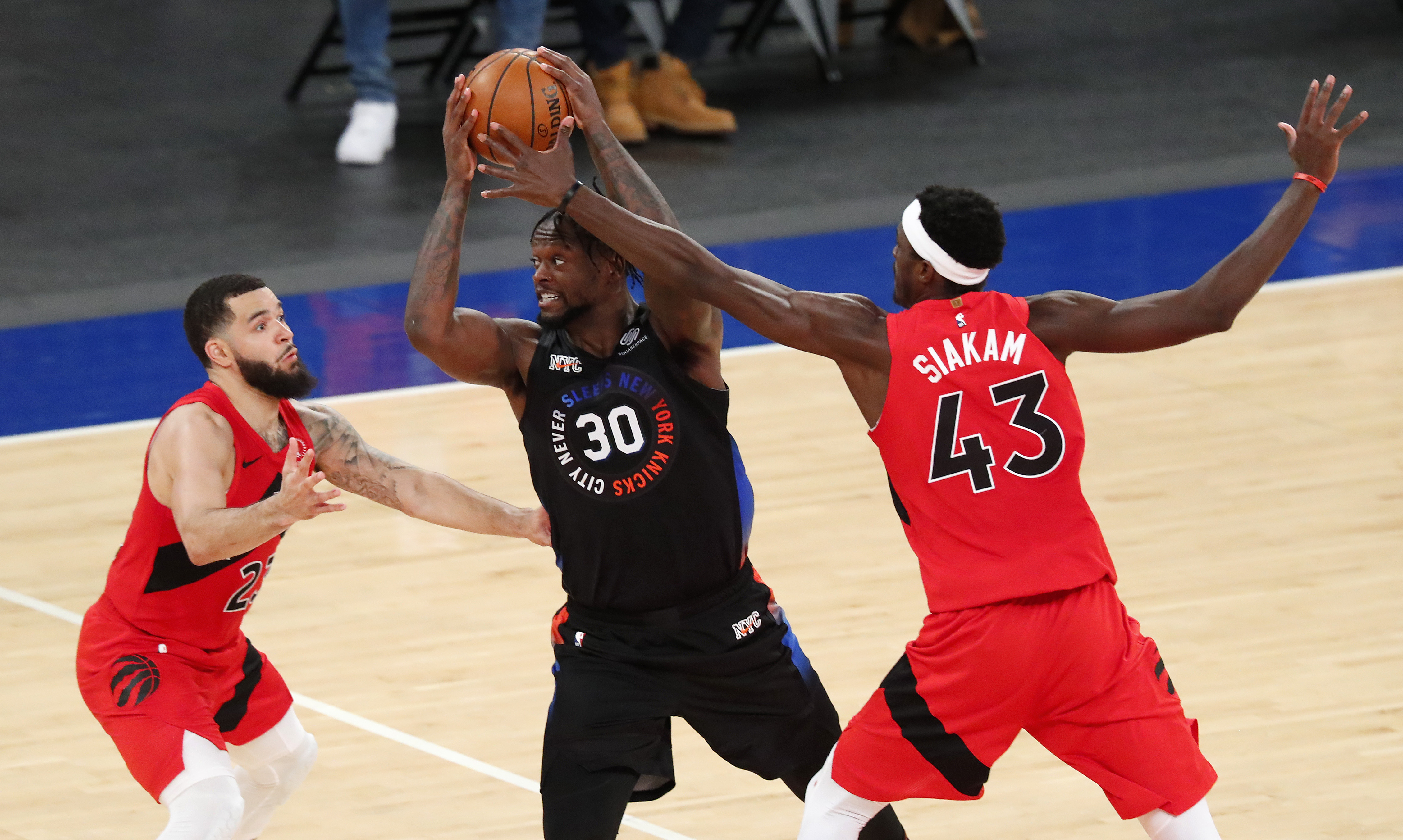 Toronto Raptors Fred VanVleet and Pascal Siakam (43) defend against New York Knicks forward Julius Randle (30) during the second half of an NBA basketball game on Saturday in New York.Photo by Noah K. Murray/Pool Photo-USA TODAY Sports