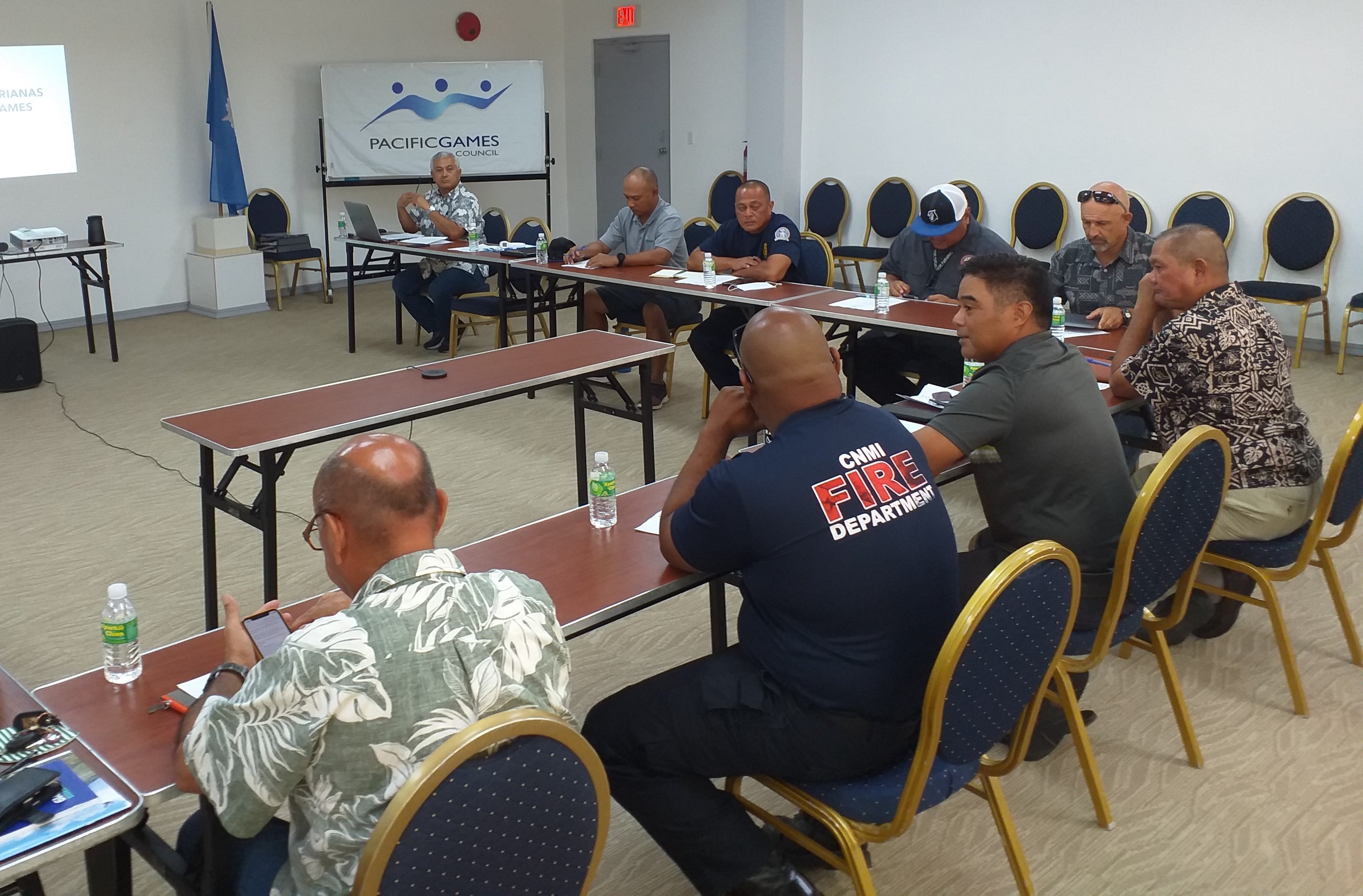 2022 Pacific Mini Games chief executive officer Ben Babauta Jr., left background, meets with the organizing committee Tuesday in the Ada gym conference room.Contributed photo