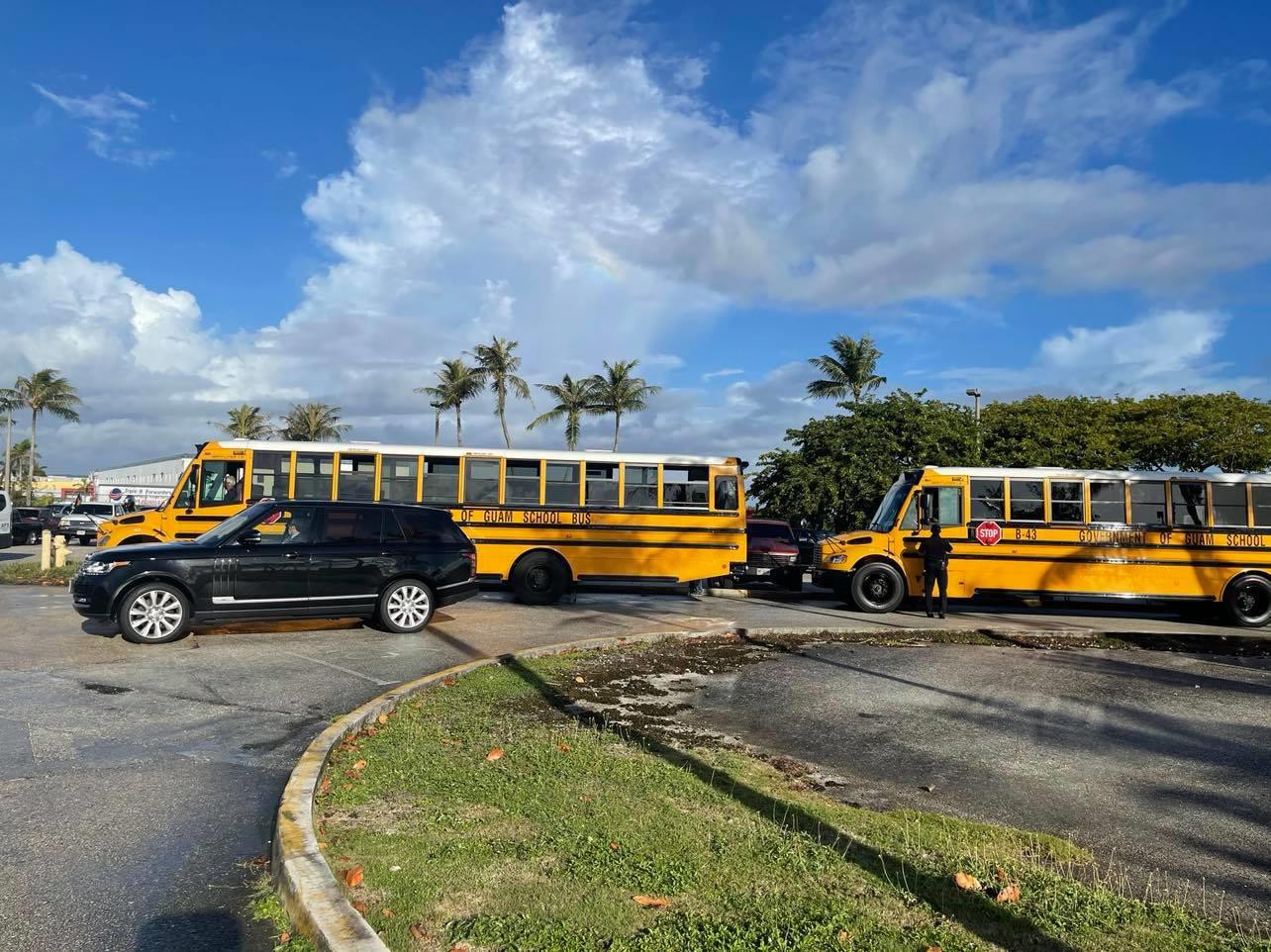 Sanitized school buses, under  escort, safely bring the stranded  citizens to the aircraft.FSMIS photo