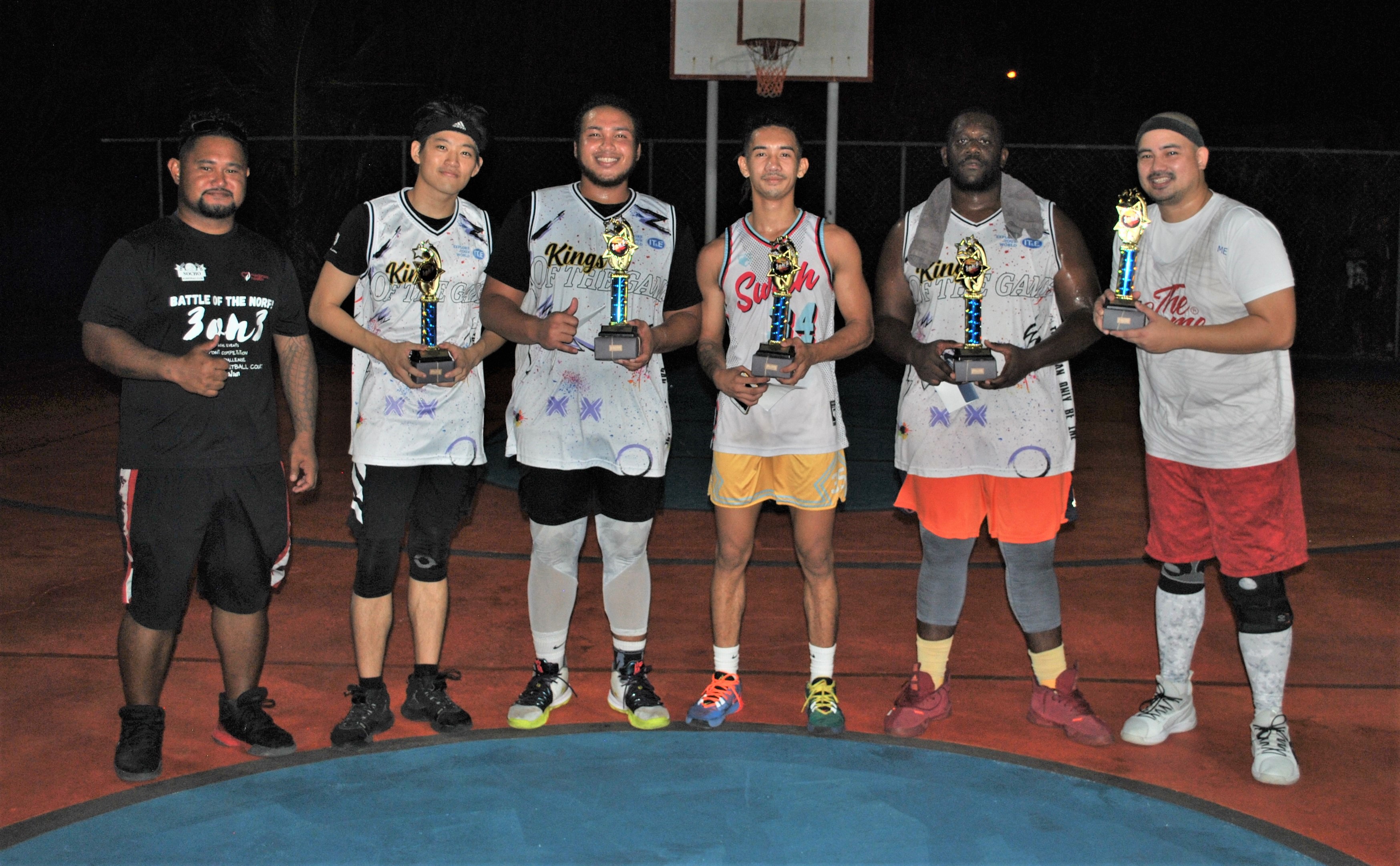 The Game team members pose with their championship trophy during the award ceremony following the championship game of the 3v3 Battle of the Norf basketball tournament Sunday at the As Matuis basketball court.Photo by James F. Sablan Jr.