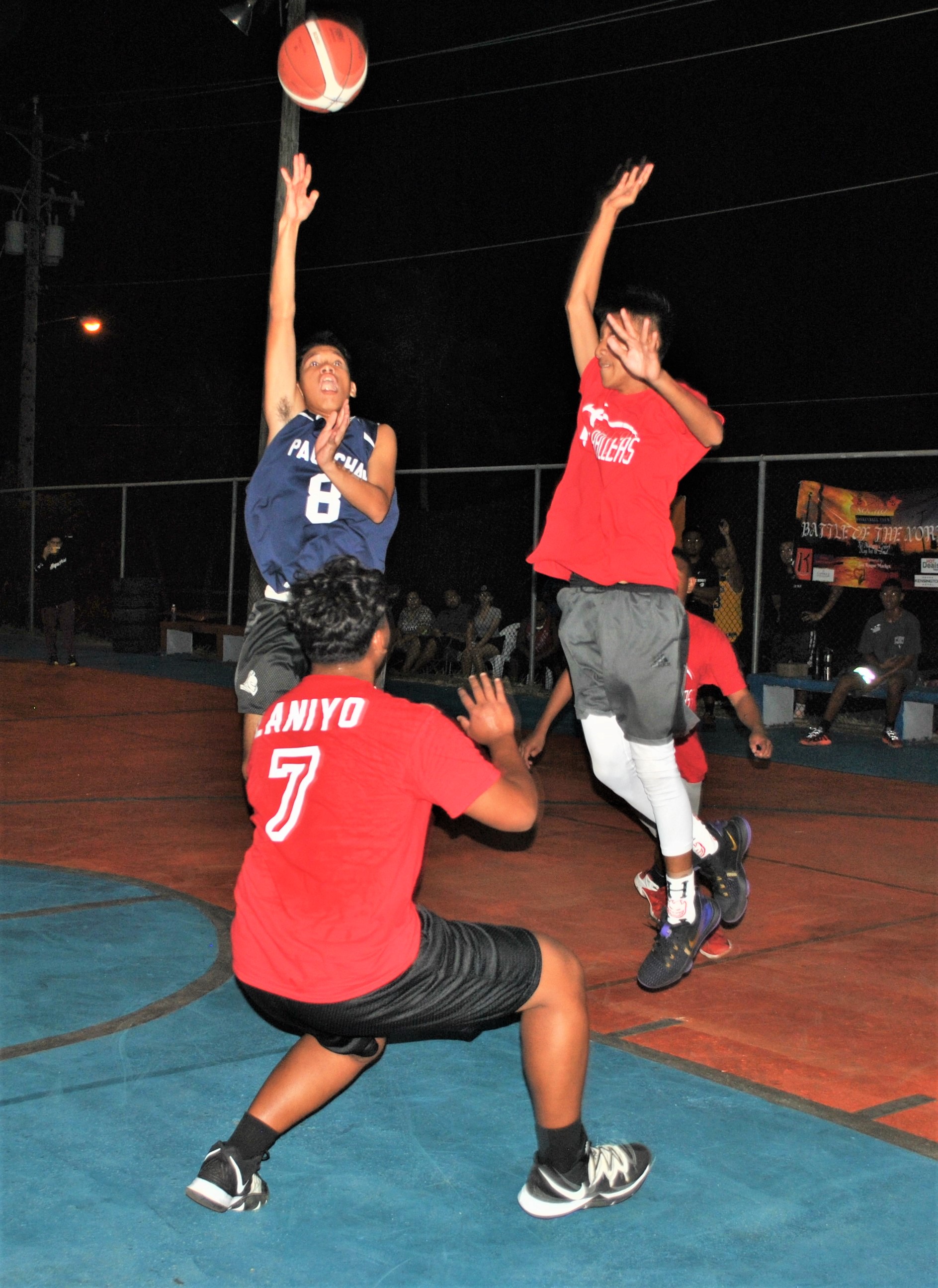Strictly Business' Leopoldo Naraja attempts the floater over two K-Town defenders in the championship game of the 3v3 Battle of the Norf basketball tournament Sunday at the As Matuis basketball court.Photo by James F. Sablan Jr.