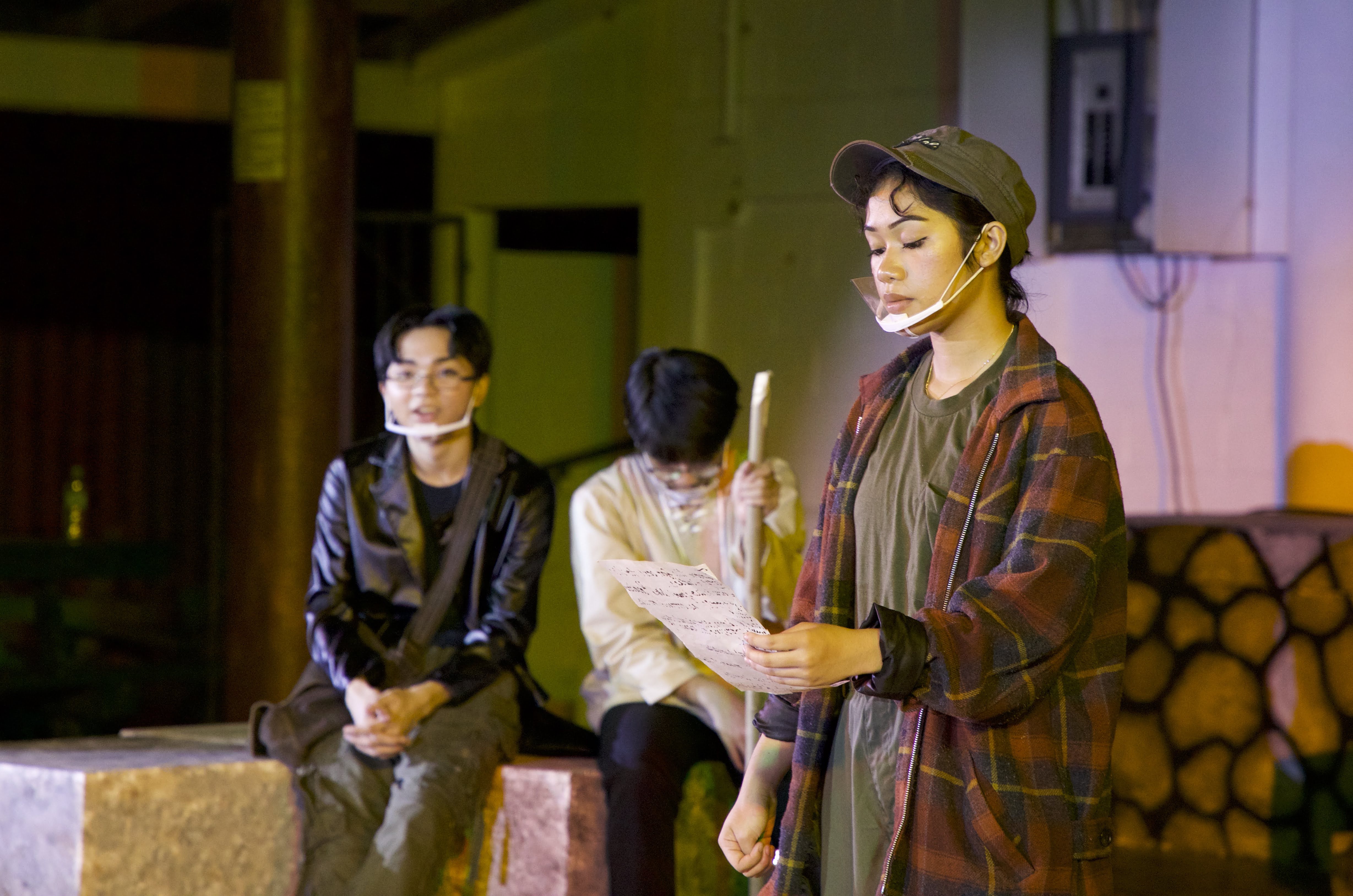 Kina Dela Cruz, right, who plays the role of Rosalind, reads her character's mysterious love letter. Also in photo are MCS sophomores Brent Ortizo, left, as Touchstone; and Donnie Militante, center, as Corin.
