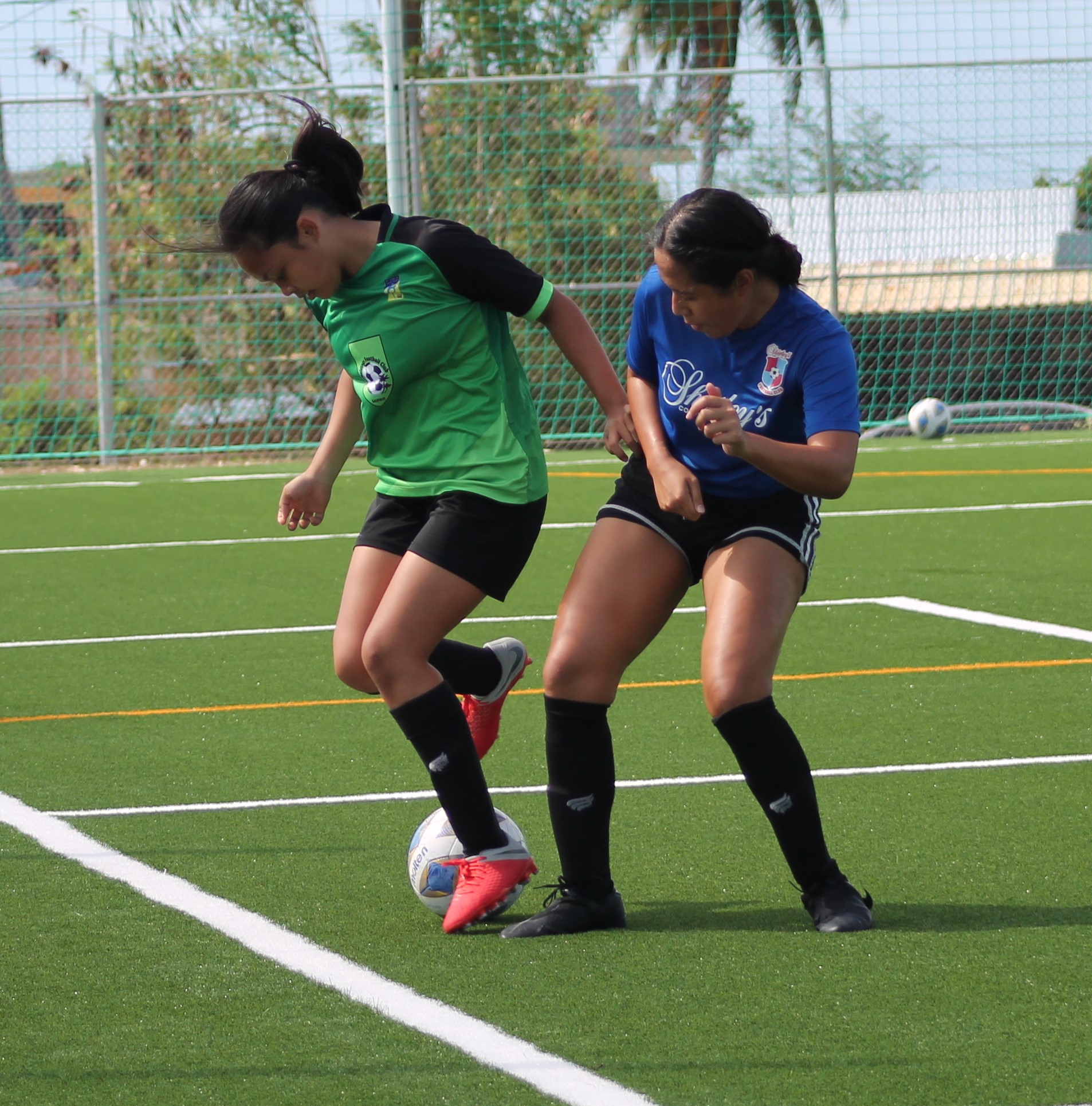 Shirley’s  Riane Capalad applies pressure as she closes in on TanHoldings’ Neriah Lumbad during a Division B game of the Dove Women's League Spring 2021 on Sunday at the NMI Soccer Training Center.Photo by James F. Sablan Jr.