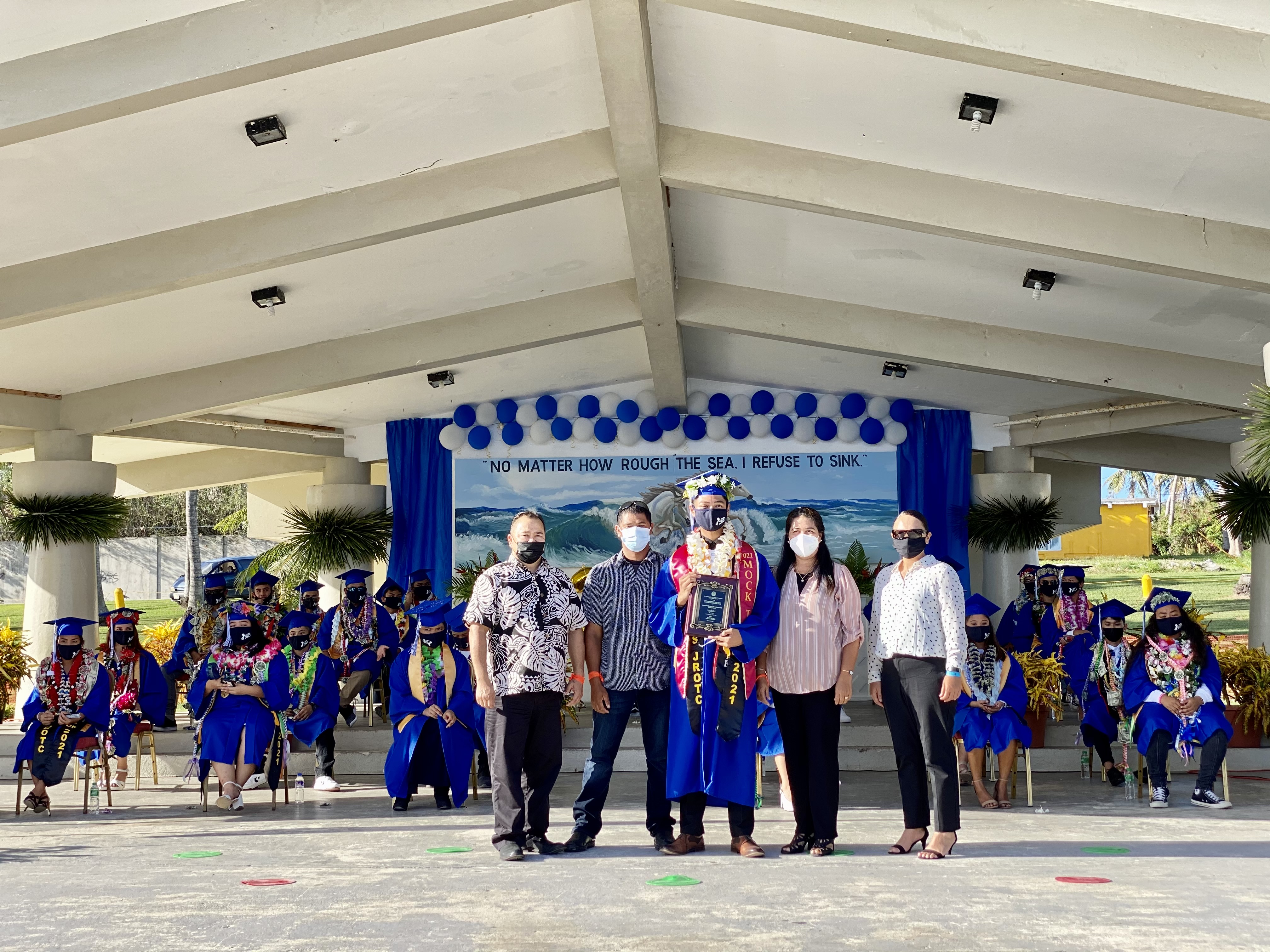 Class of 2021 salutatorian and Commissioner of Education awardee Clarence Paraise Rodriguez poses with his mother Riza and step-father Olympo, Education Commissioner Dr. Alfred B. Ada and school principal Dionne Santos.