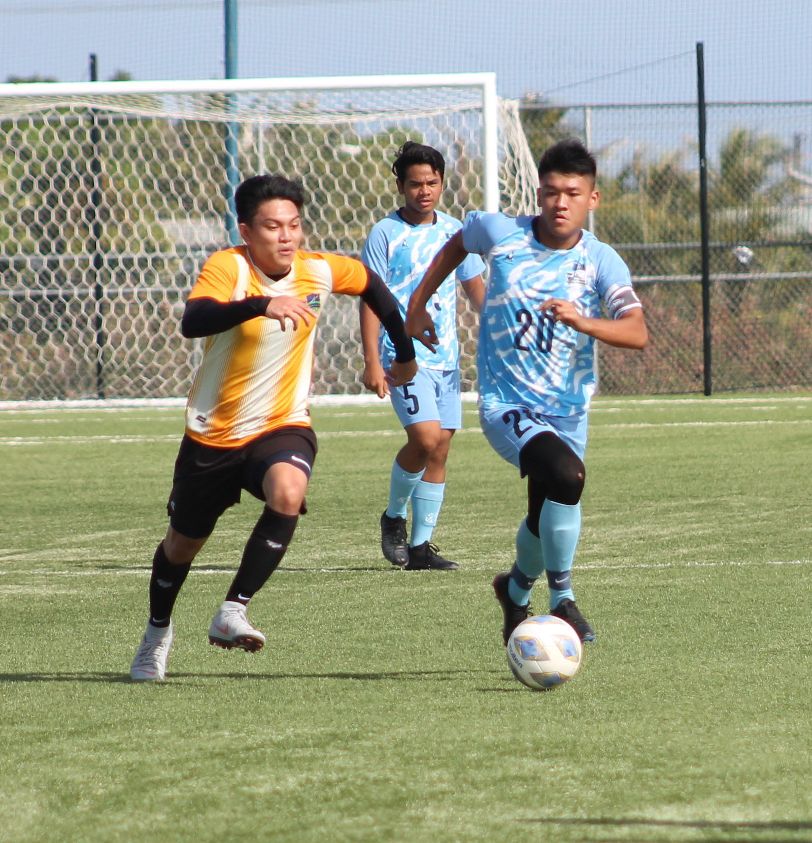 U18 Team A's Taka Borja dribbles forward as a Kanoa defender closes in during a Men's M-League Spring 2021 game on Sunday at the NMI Soccer Training Center.Photo by James F. Sablan Jr