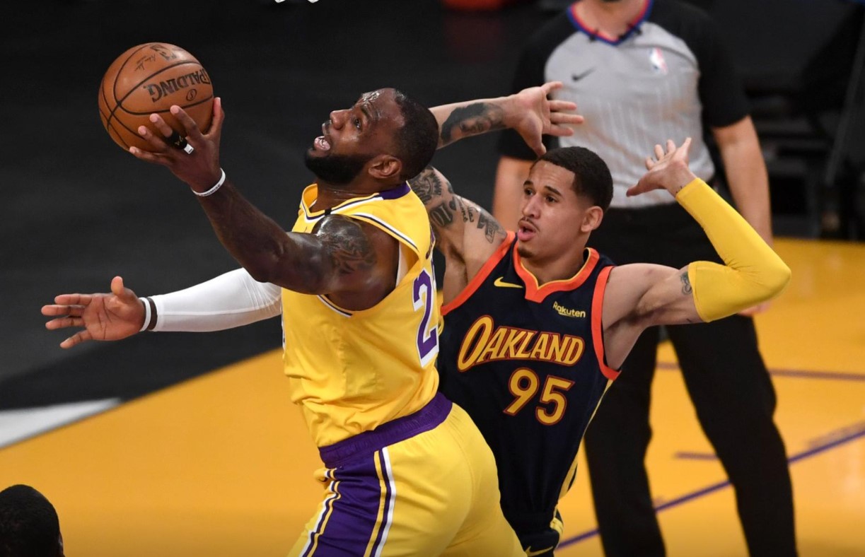 Los Angeles Lakers forward LeBron James (23) gets past Golden State Warriors forward Juan Toscano-Anderson (95) for a basket in the first quarter of the game at Staples Center in Los Angeles on Wednesday.Photo by Jayne Kamin-Oncea-USA TODAY Sports