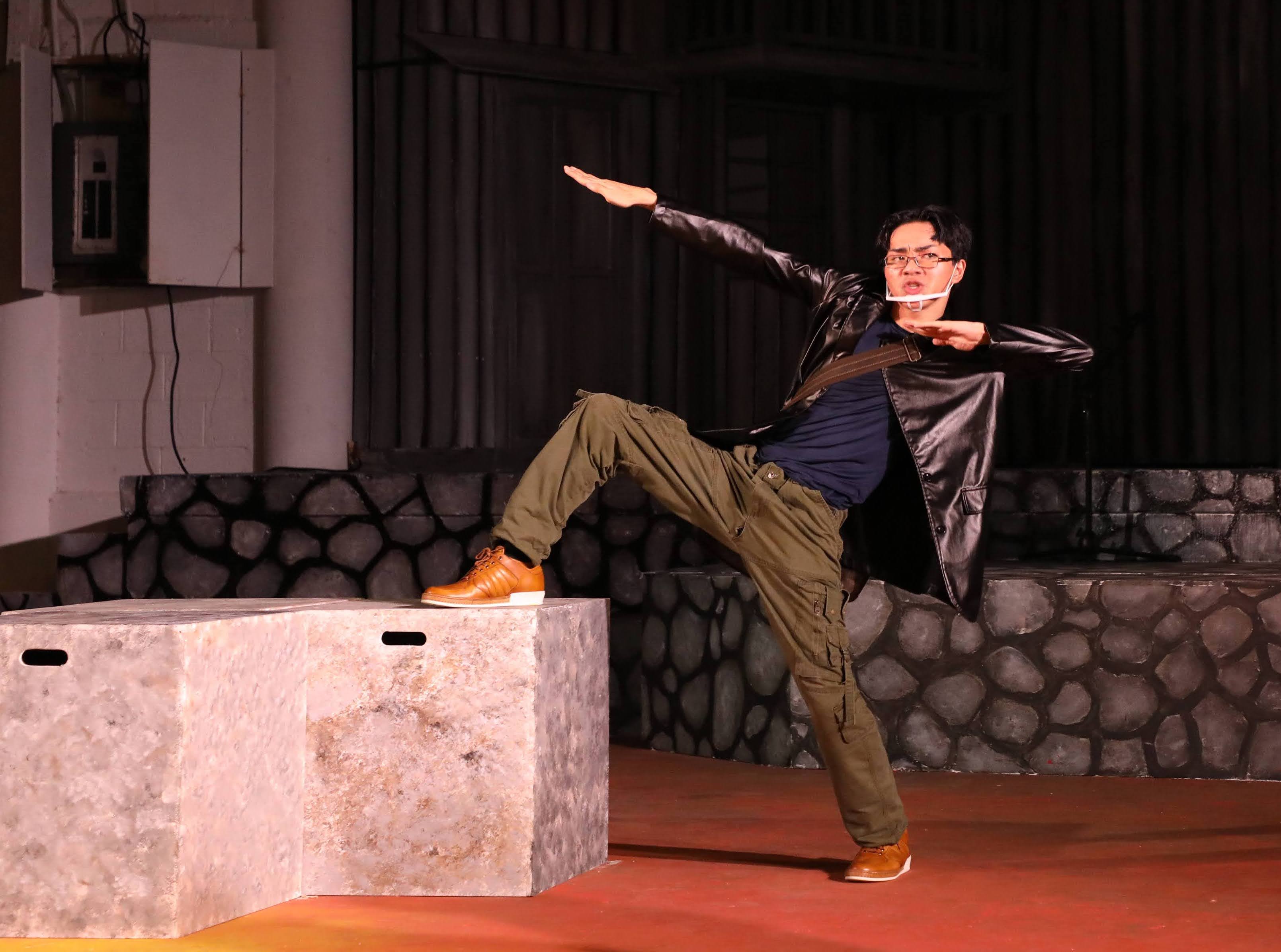 Touchstone, portrayed by Mount Carmel School sophomore Brent Ortizo, attempts to impress a young lady.