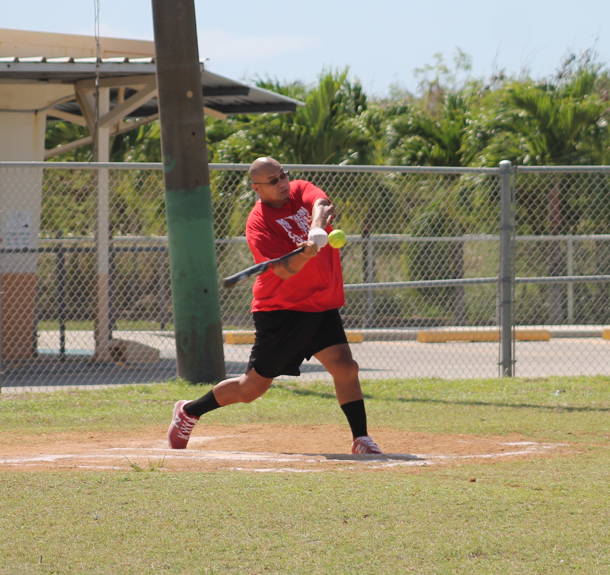 Man Amigos' David Attao connects the hit during a game of the Belau Amateur Softball League Sunday at the Dandan baseball field.Photo by James F. Sablan Jr.