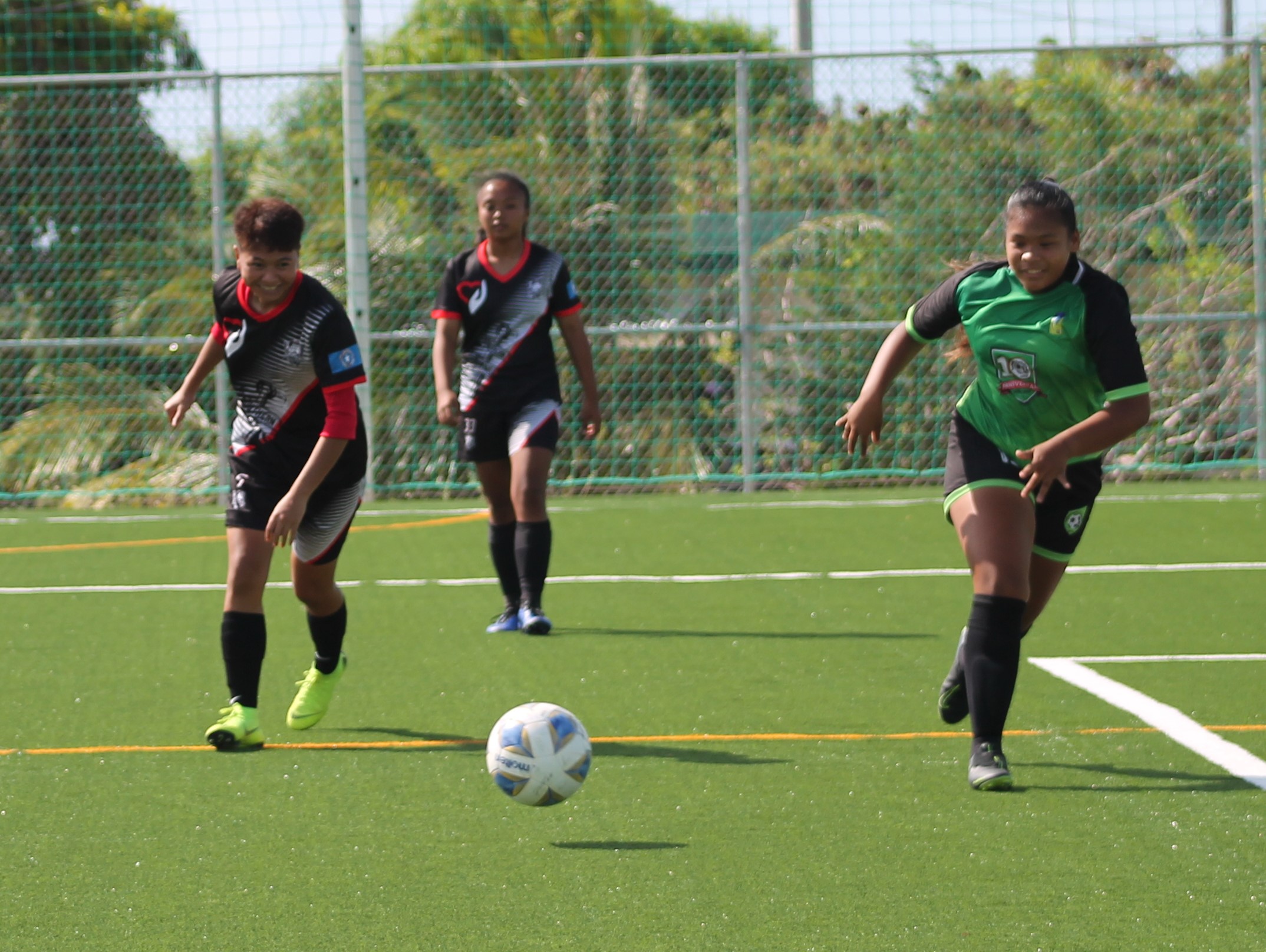 Southern United Football Club’s Britany Wally and TanHoldings's Rizza Relucio race for the possession during a Division A game of the Dove Women's Spring League on Sunday at the NMI Soccer Training Center.Photo by James F. Sablan Jr.