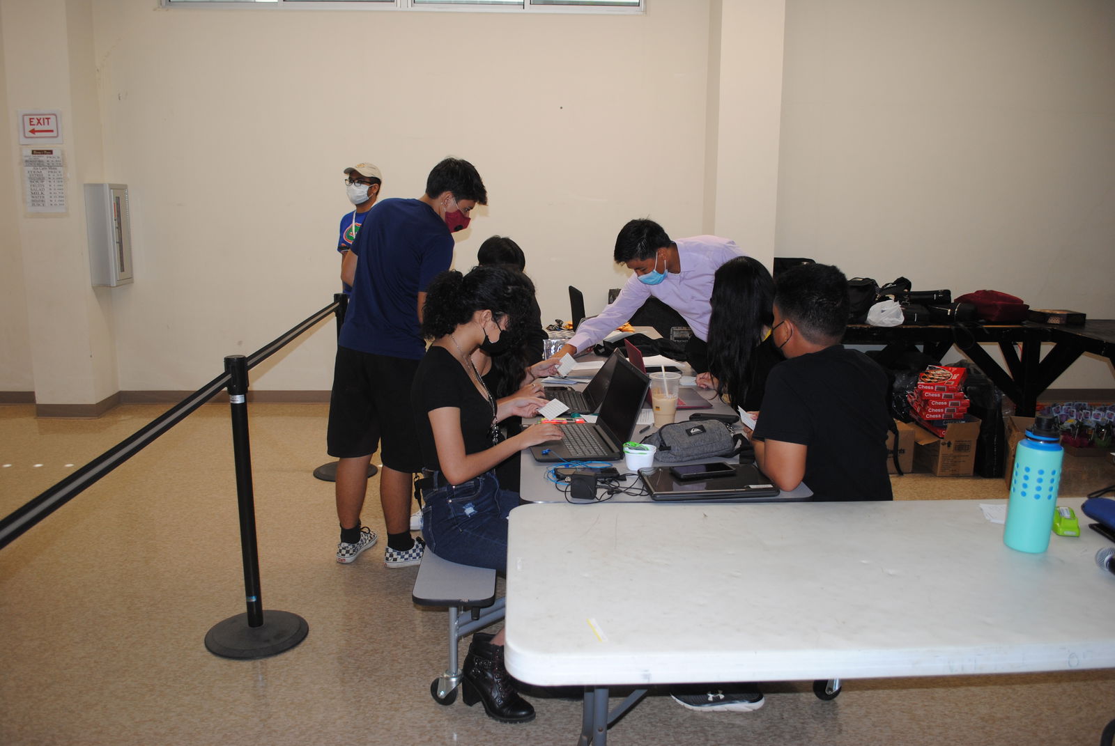 International Chess Club president Joseph Zhang works with the volunteer tabulators to determine the pairings for the next round.MV photo