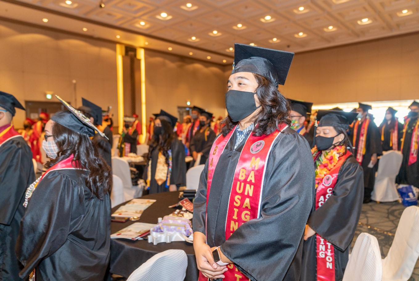 Ezekiel Macario, center, is seen with other NMC graduates at Saipan World Resort.