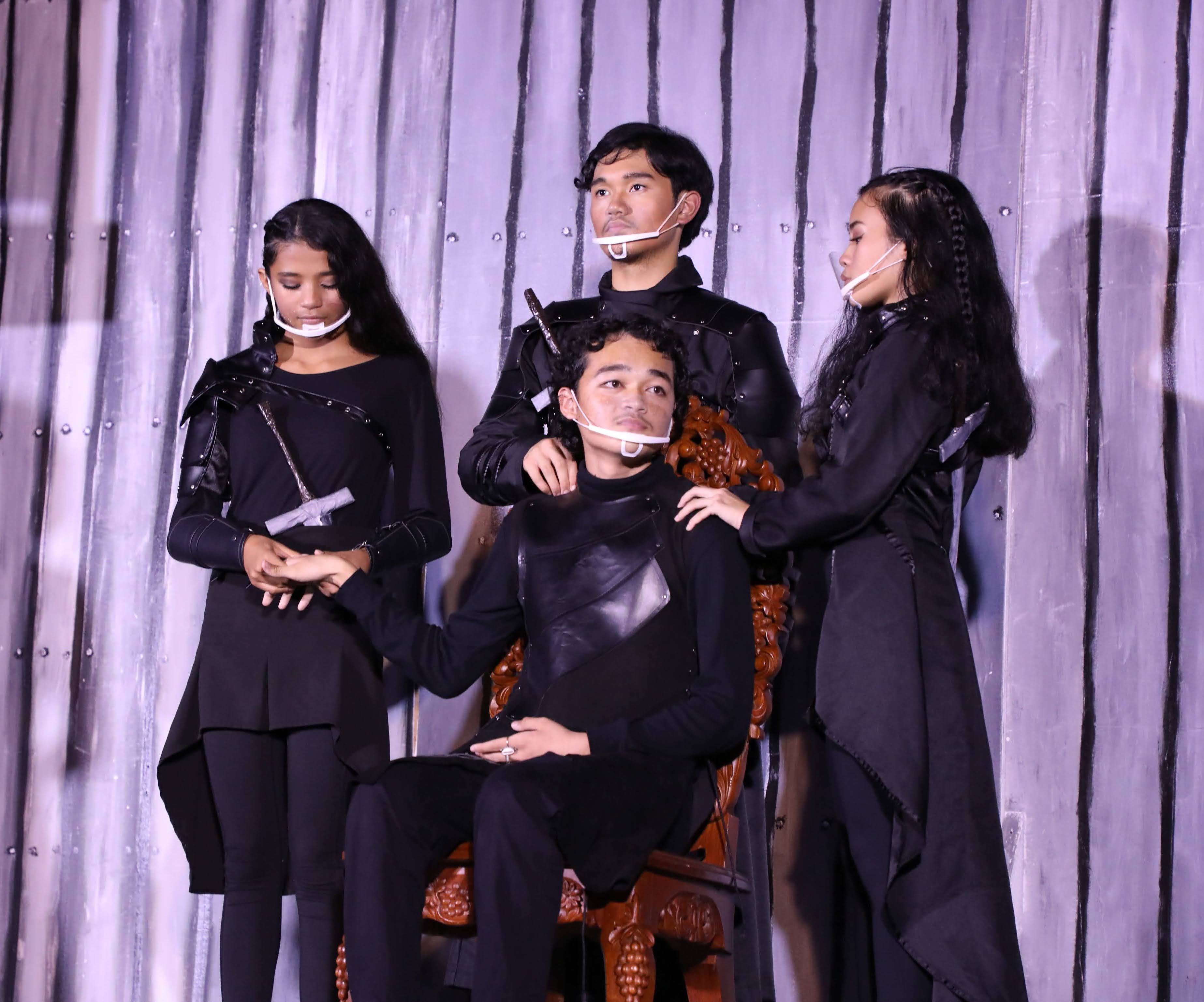 Duke Fredrick, portrayed by MCS senior Sinahi Cepeda, sitting at center, is pampered by his guards. Also in the photo are eighth-grade student Maili Peter, standing left, MCS senior Christian Palattao, standing center, and MCS junior Theresa Schweiger, standing right.