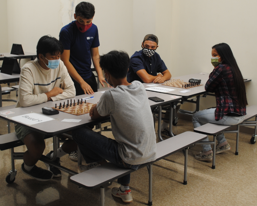 One of the volunteer arbiters, Jonathan Wolf, standing, reminds players about the rules before the start of the first round.MV photo