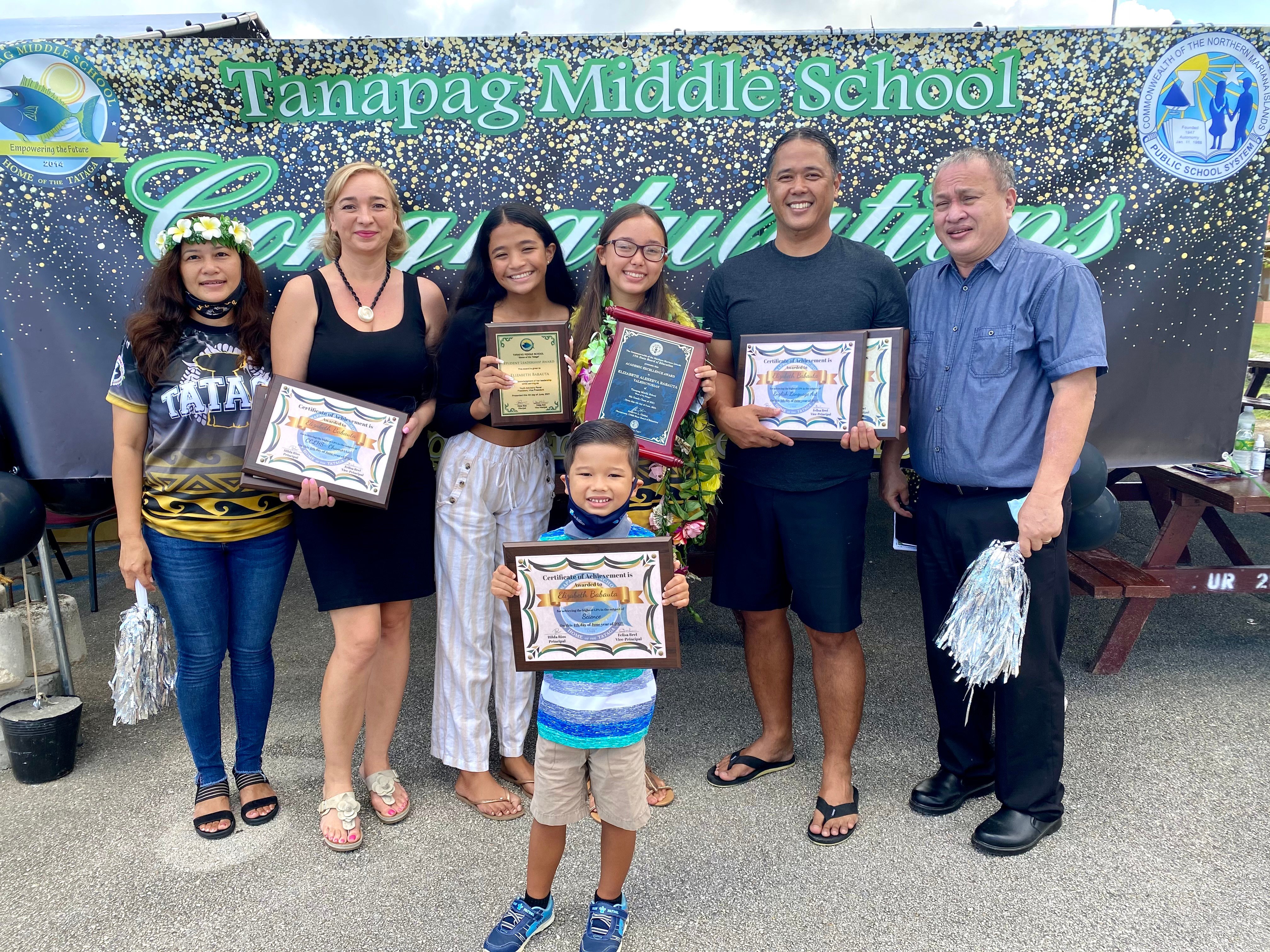 Newly promoted eighth grader Elizabeth Babauta is Tanapag Middle School’s valedictorian and recipient of the Board of Education Academic Achievement Award. Also in photo are her family, school principal Hilda Rios and BOE Chairman Andrew L. Orsini.