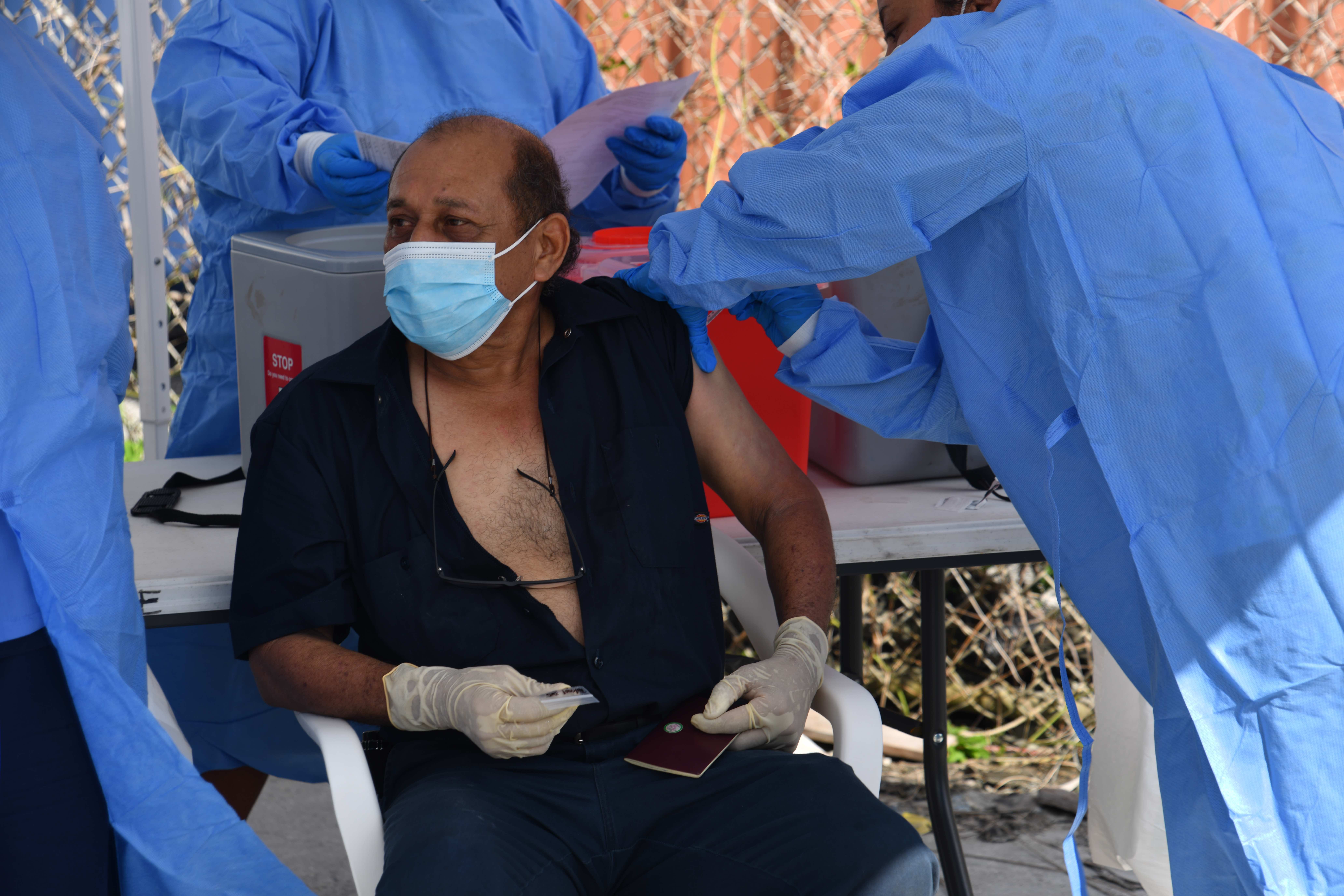 A commercial fisherman from a purse seine fishing vessel receives his Covid vaccine from a public health nurse in Majuro on June 9.