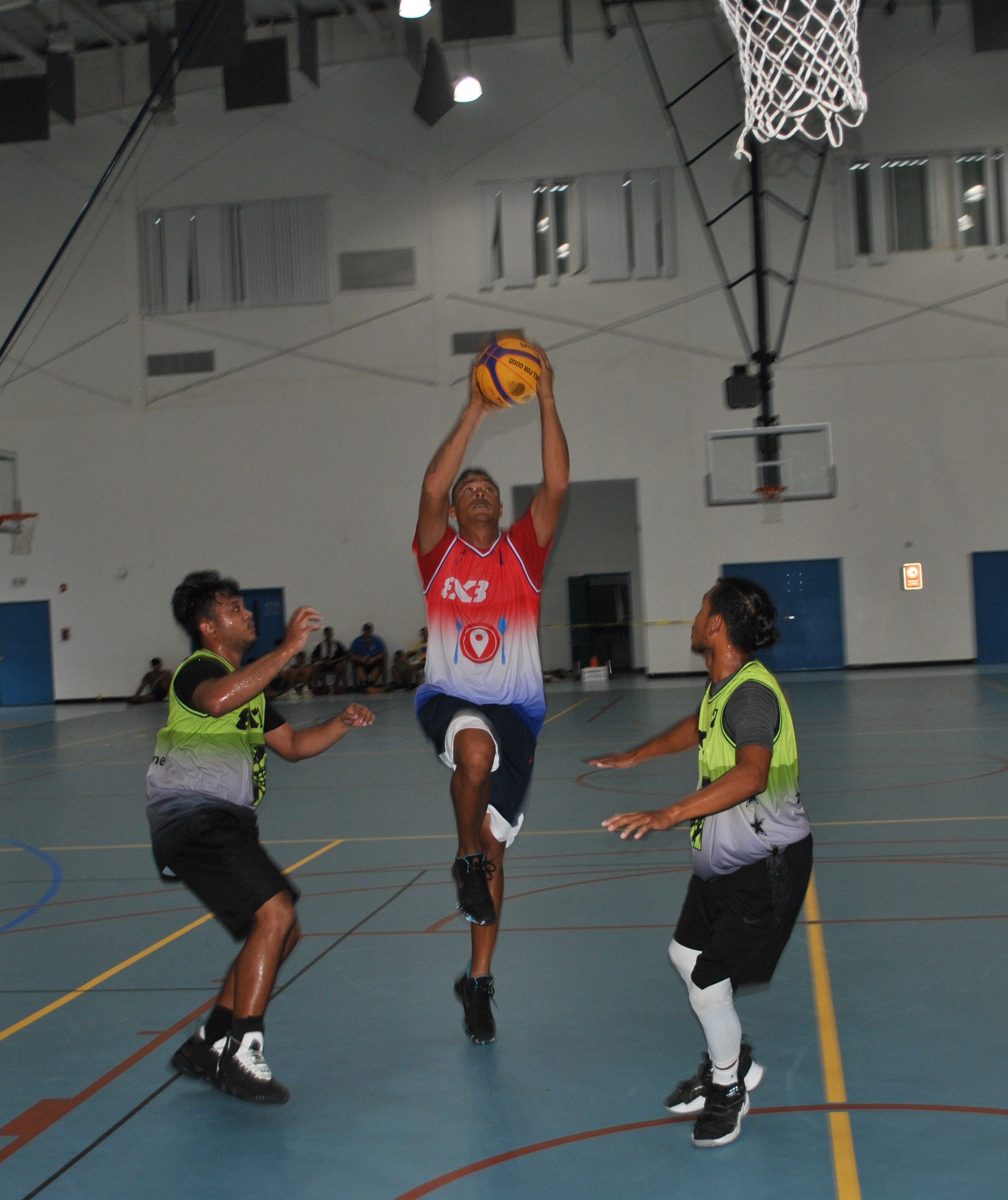 Hole in the Wall's Dennis Mendiola rises up for the finish against two Mix Breed defenders during the MIBL 3x3 championship game at the MHS gym on Sunday.