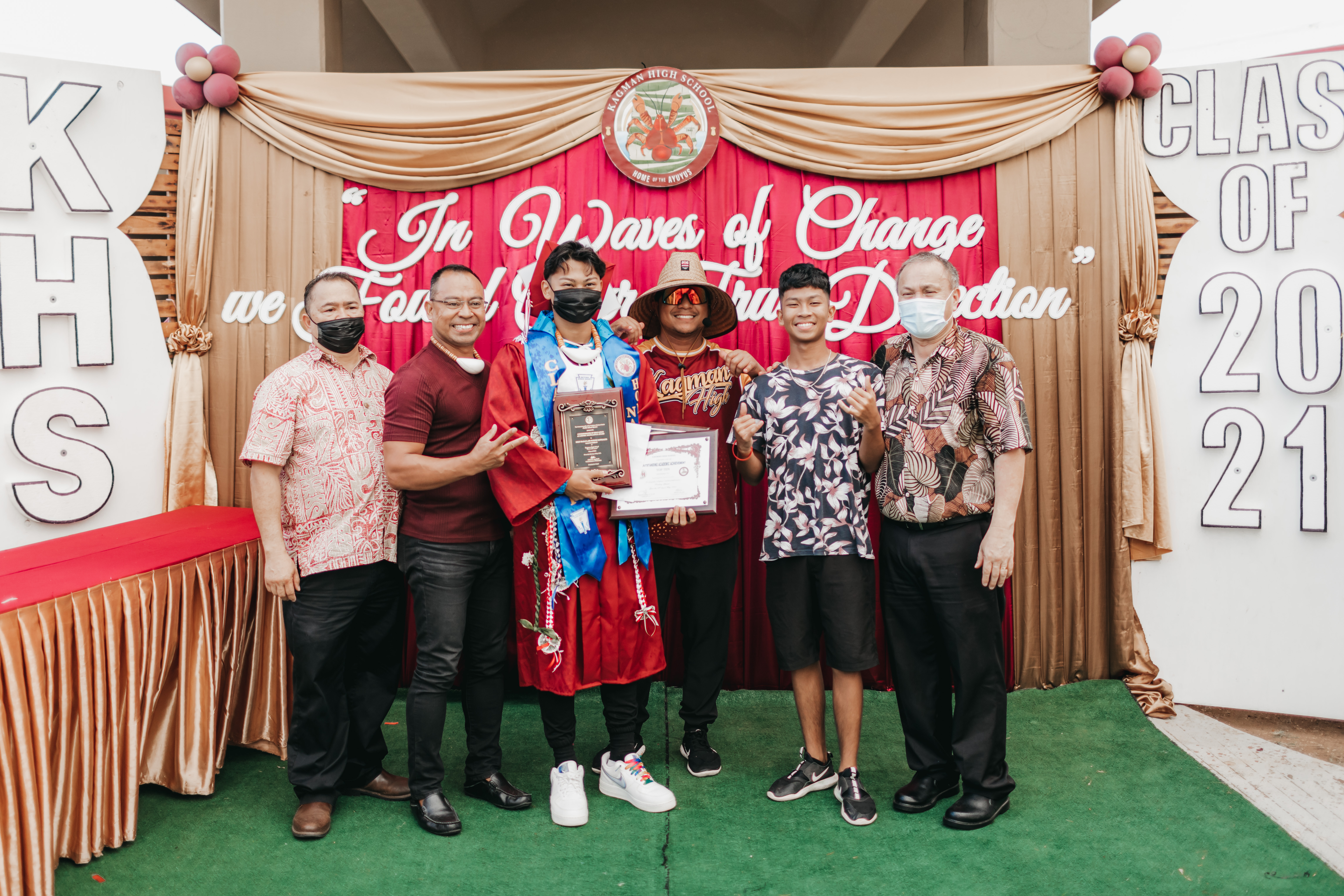 Kagman High School Class of 2021 salutatorian and Commissioner of Education awardee Seiji Maga'lahi Suzuki Gonzales poses for a photo with Education Commissioner Dr. Alfred B. Ada, Board of Education Chairman Andrew Orsini, Seiji’s father John Oliver Gonzales, Seiji’s brother, and KHS principal Ben Jones.
