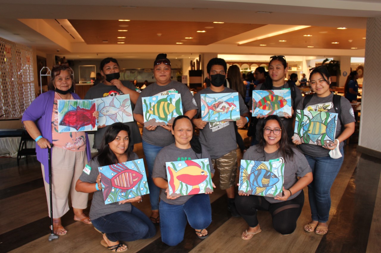 PSS personnel display the artwork they created during the self-care painting activity.