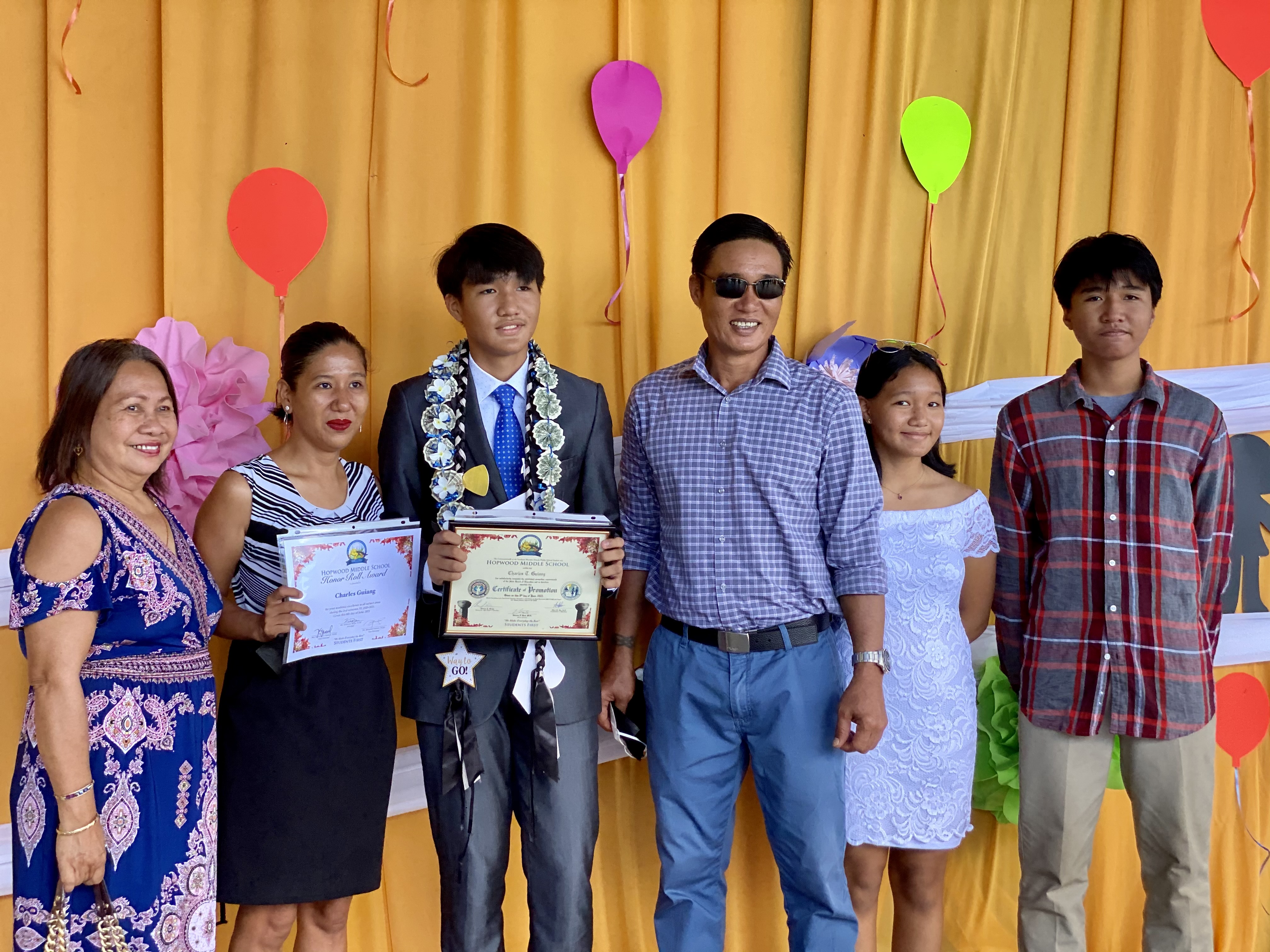 Charles Guiang and his family celebrate his promotion.