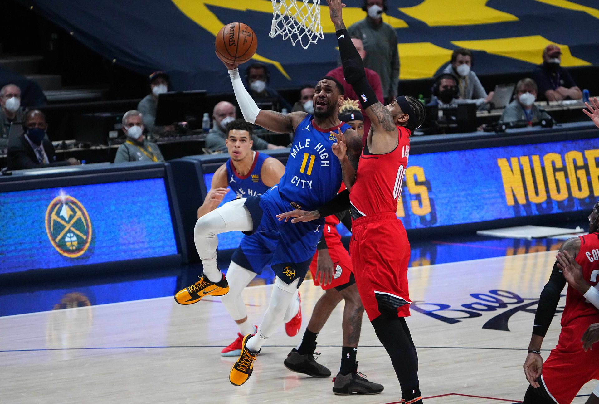 Denver Nuggets guard Monte Morris (11) shoots the ball past Portland Trail Blazers forward Carmelo Anthony (00) in the second quarter during game five in the first round of the 2021 NBA Playoffs. at Ball Arena in Denver, Colorado on June 1, 2021.