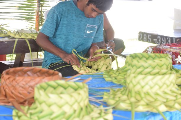 Billy Boy Olaitiman weaves traditional hats.