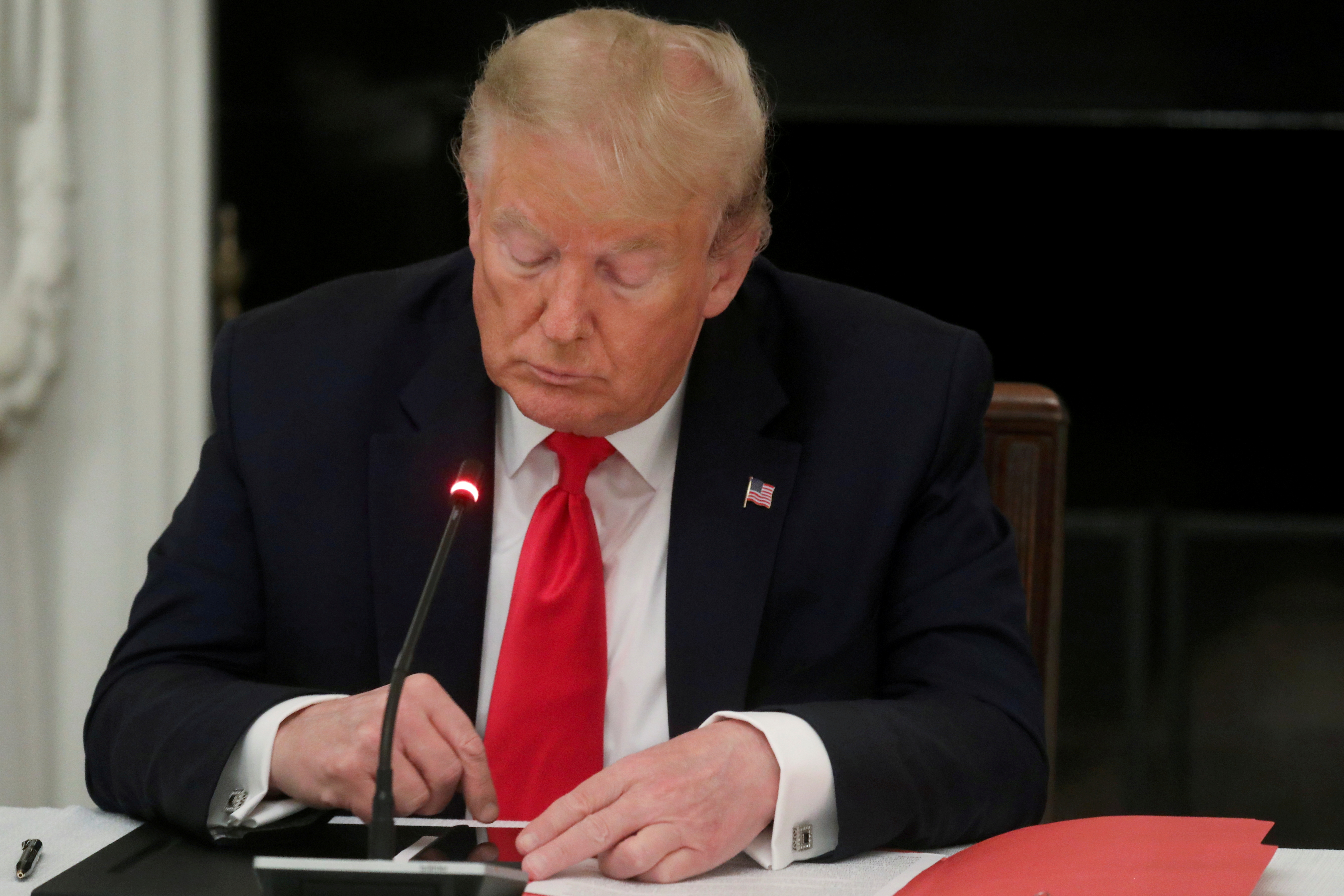 Then-President Donald Trump is seen tapping the screen on a mobile phone at the White House in Washington, D.C. on June 18, 2020.