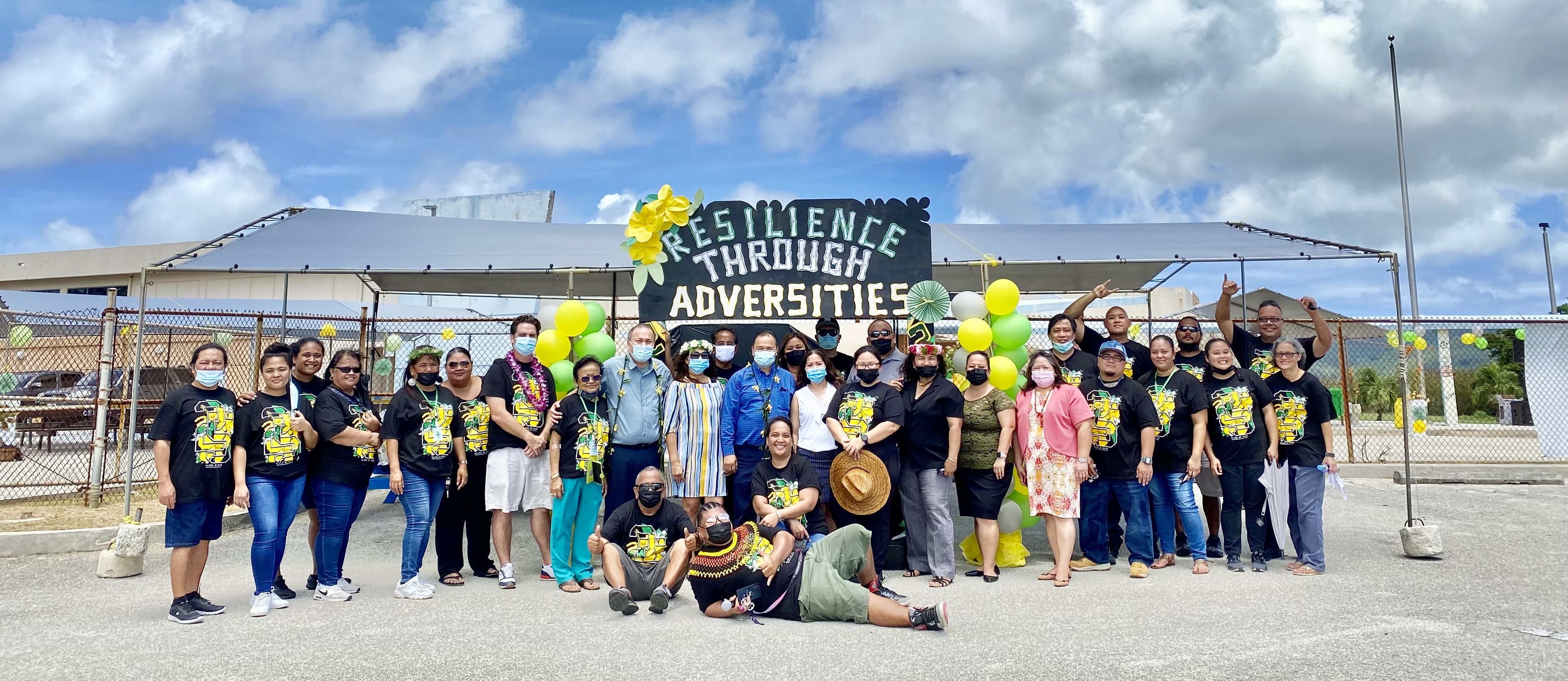 The Chacha Oceanview Middle School administrators and staff pose for a photo with education officials following the promotion ceremony on campus, June 3, 2021.