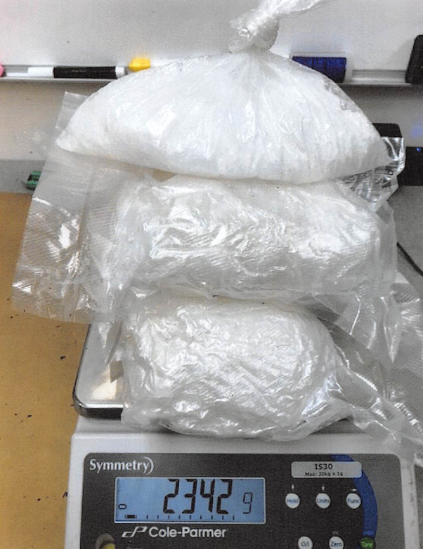 Federal authorities weigh 2,342 grams of crystal methamphetamine in three plastic bags following the seizure of the drugs from a U.S. Postal Service priority package in September 2018. In another federal investigation on Guam, authorities intercepted 8 pounds of methamphetamine recently.