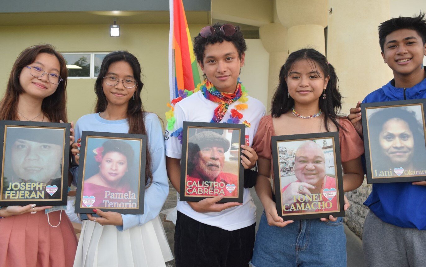 Members of the Pride Marianas Youth hold the photographs of Joseph Fejeran, Pamela Tenorio, Calistro Cabrera, Tonei Camacho and Lani Okaruru to pay tribute to them during the Strides for Pride parade from Garapan Fishing  Base to American Memorial Park on Friday.