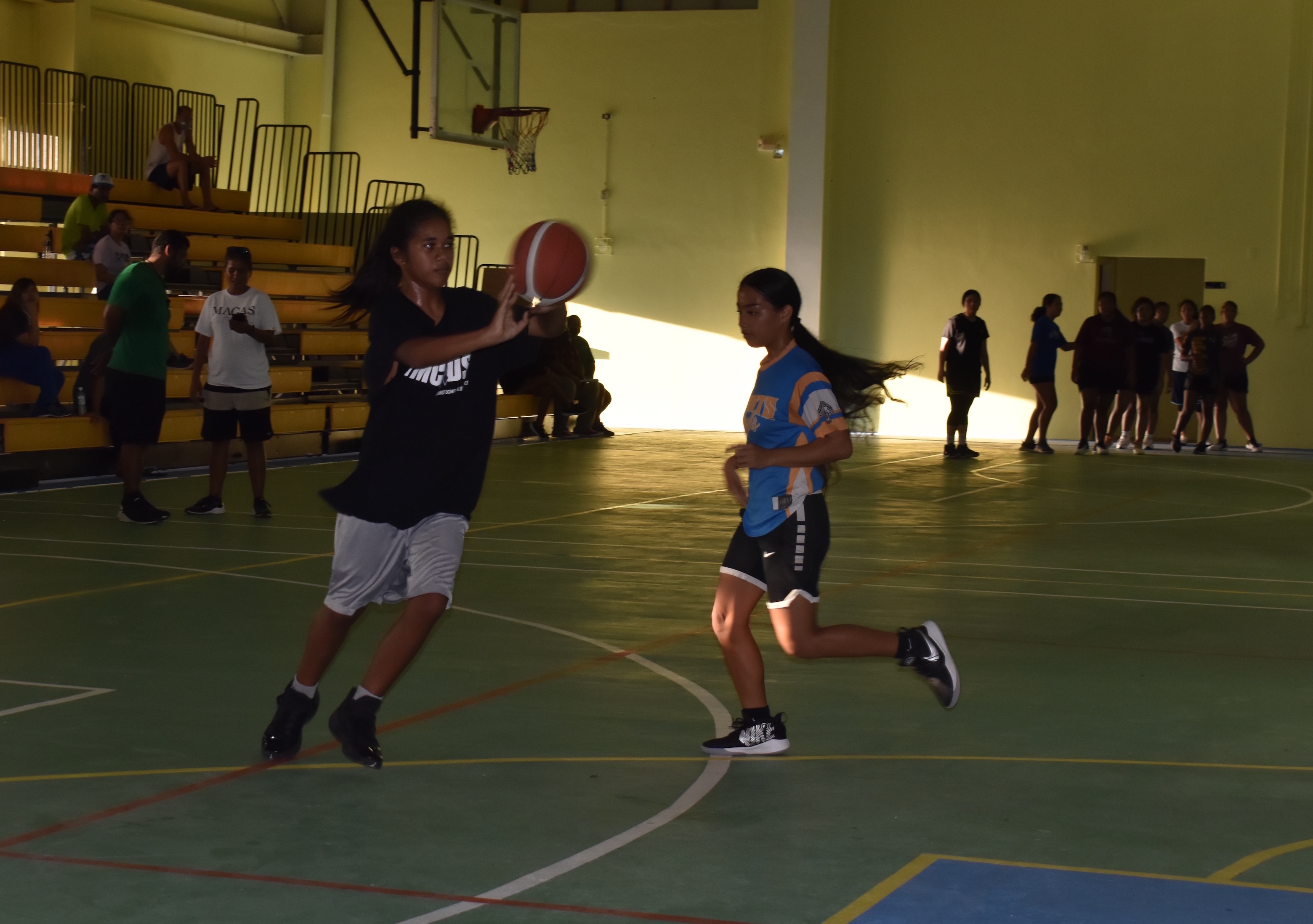 Two female players perform drills during the Northern Mariana Islands Basketball Federation’s national program tryouts  Tuesday night at the Gilbert C. Ada Gymnasium.